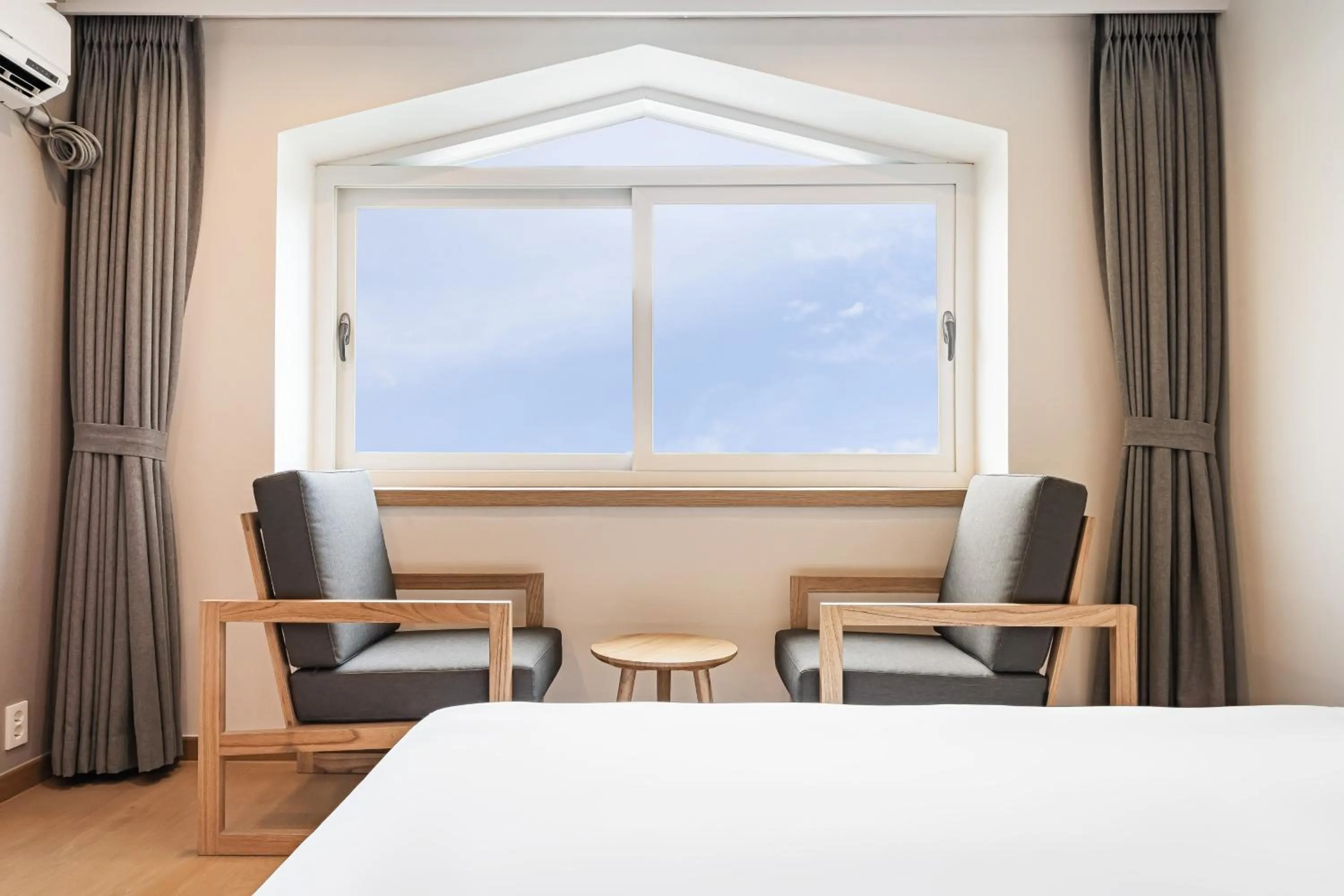 Living room, Bed in Heyy Seogwipo Hotel