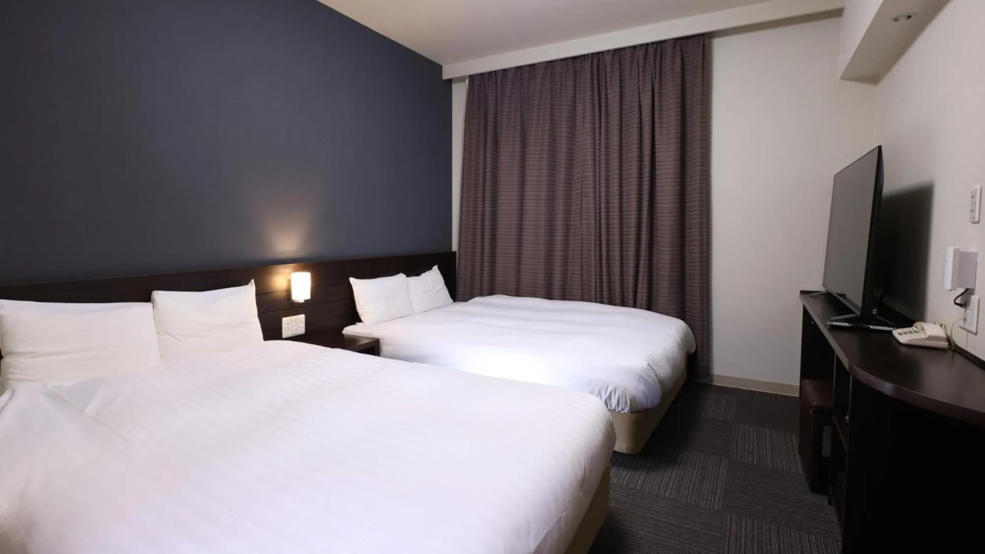 Bed in Dormy Inn Sendai Annex