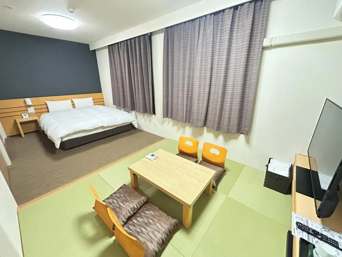 Communal lounge/ TV room, Bed in Dormy Inn Akita
