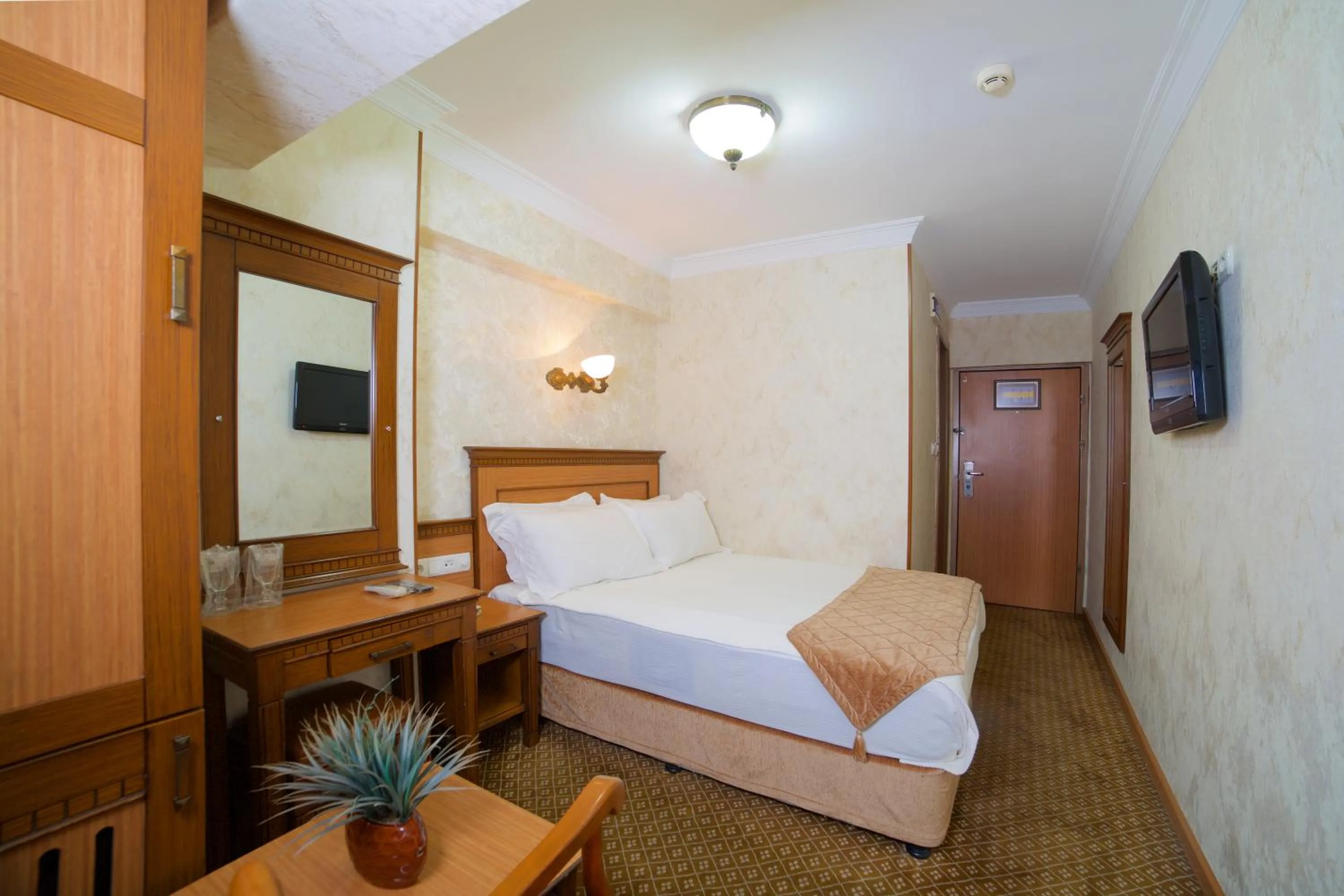 Bed in Grand Unal Hotel