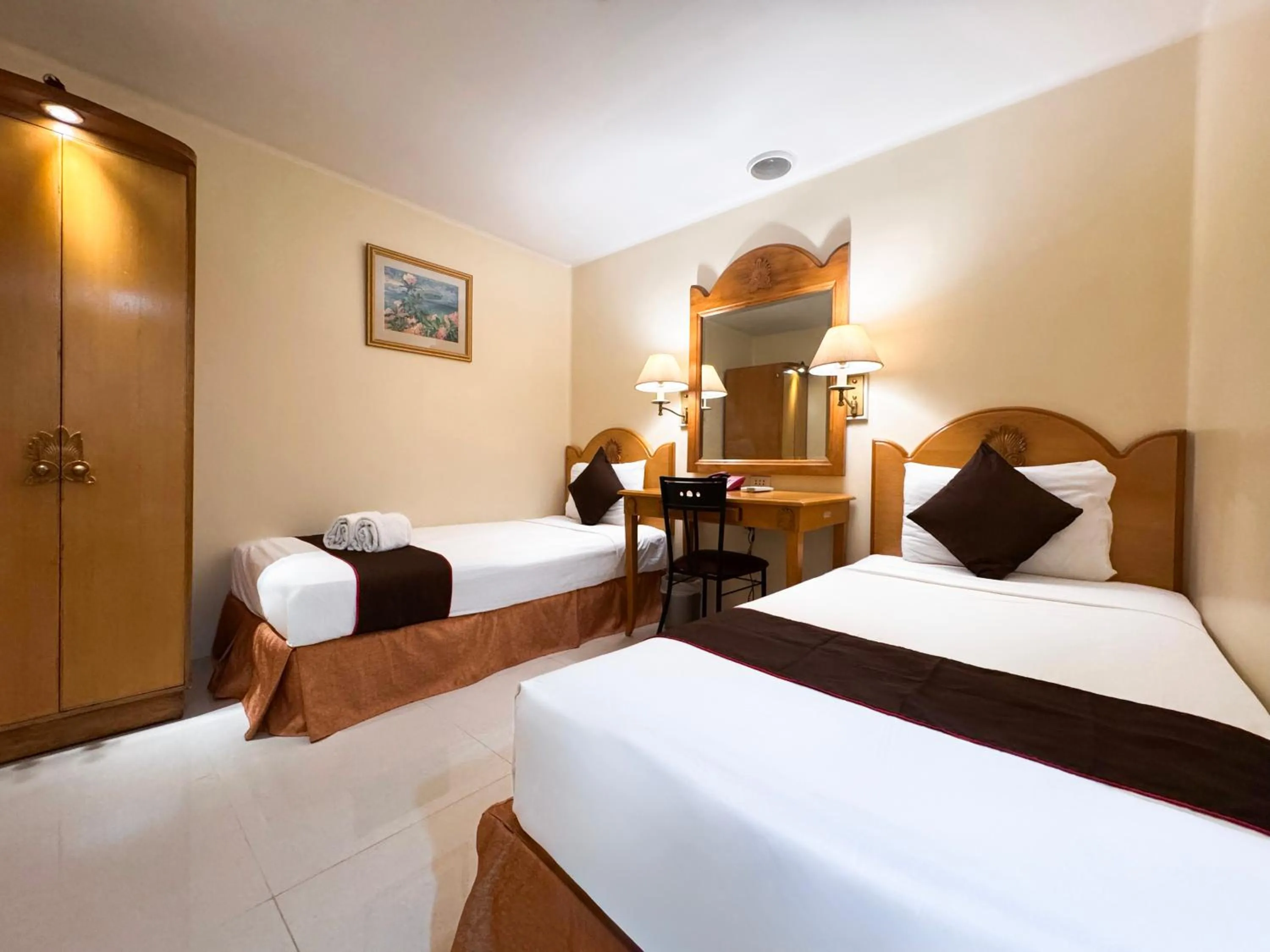 Bed in Palladium Suites Hotel