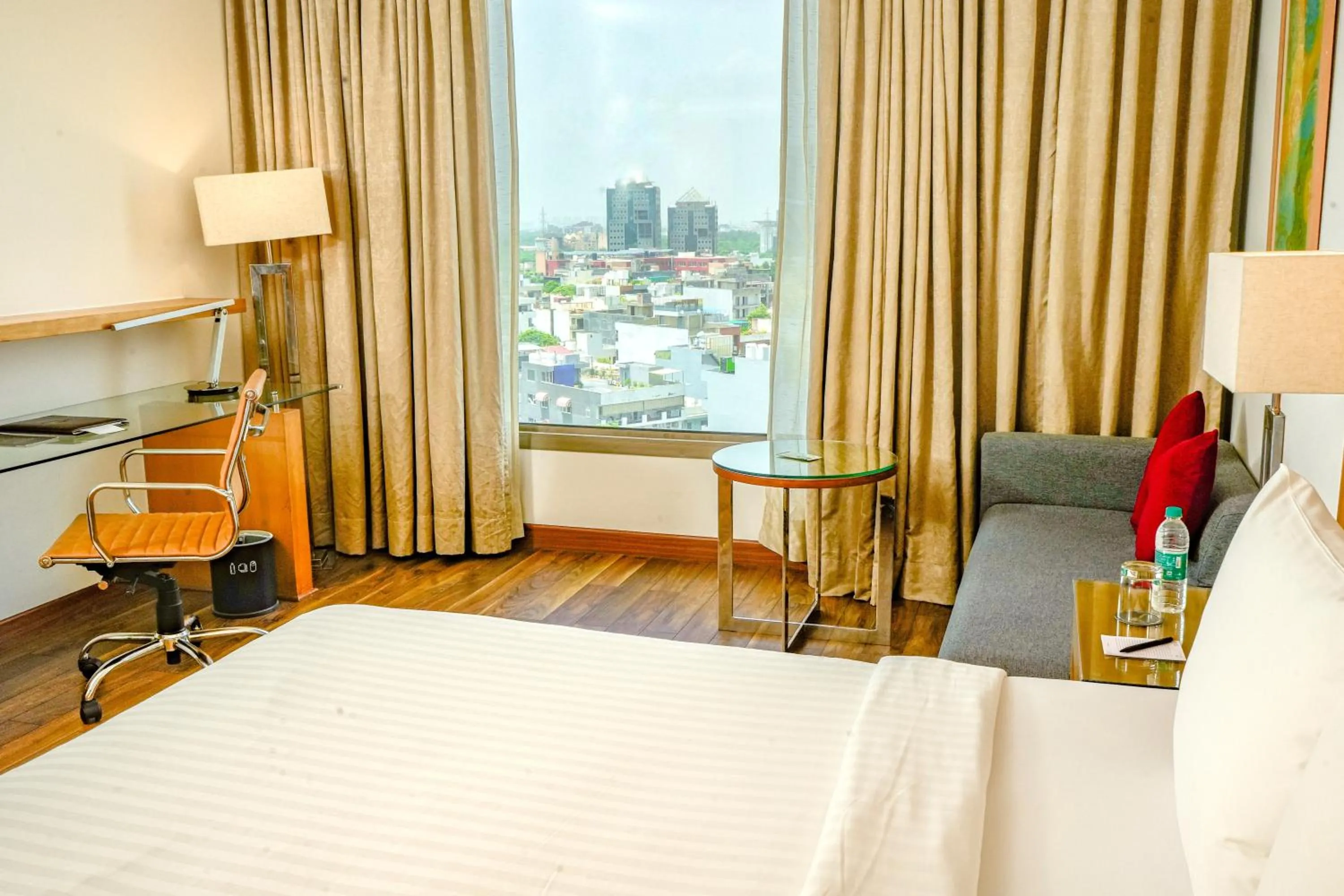 Seating area, Bed in Courtyard by Marriott Gurugram Downtown