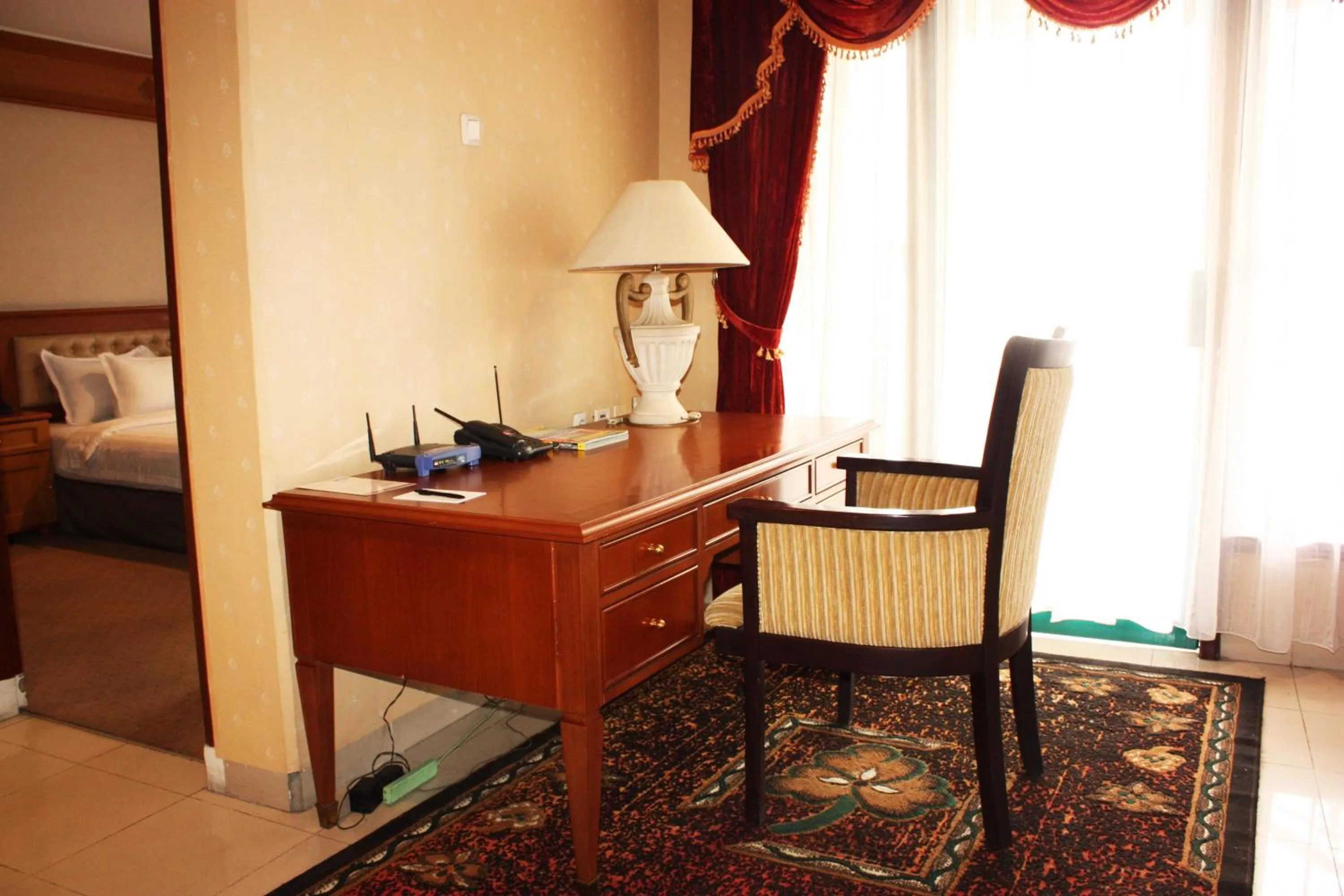 Seating area, Bed in Travellers Suites Serviced Apartments
