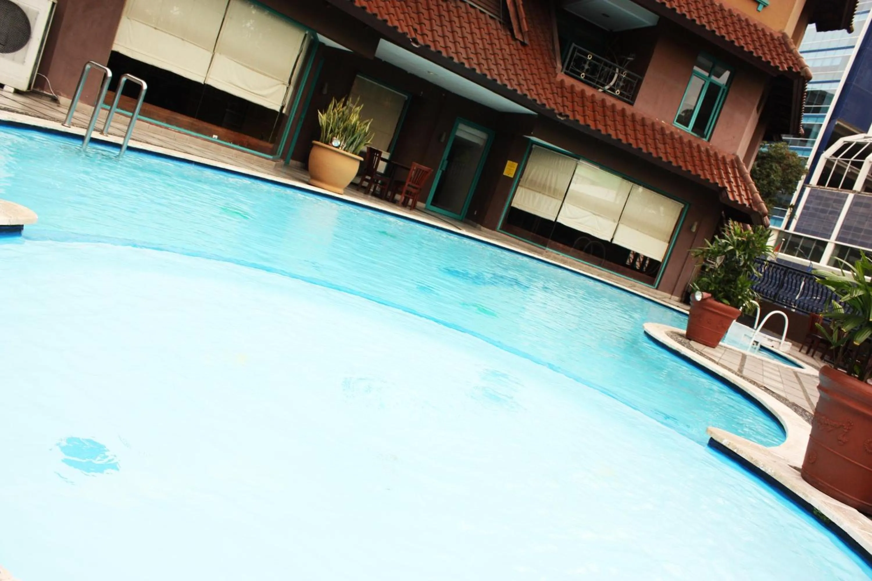 Swimming pool in Travellers Suites Serviced Apartments