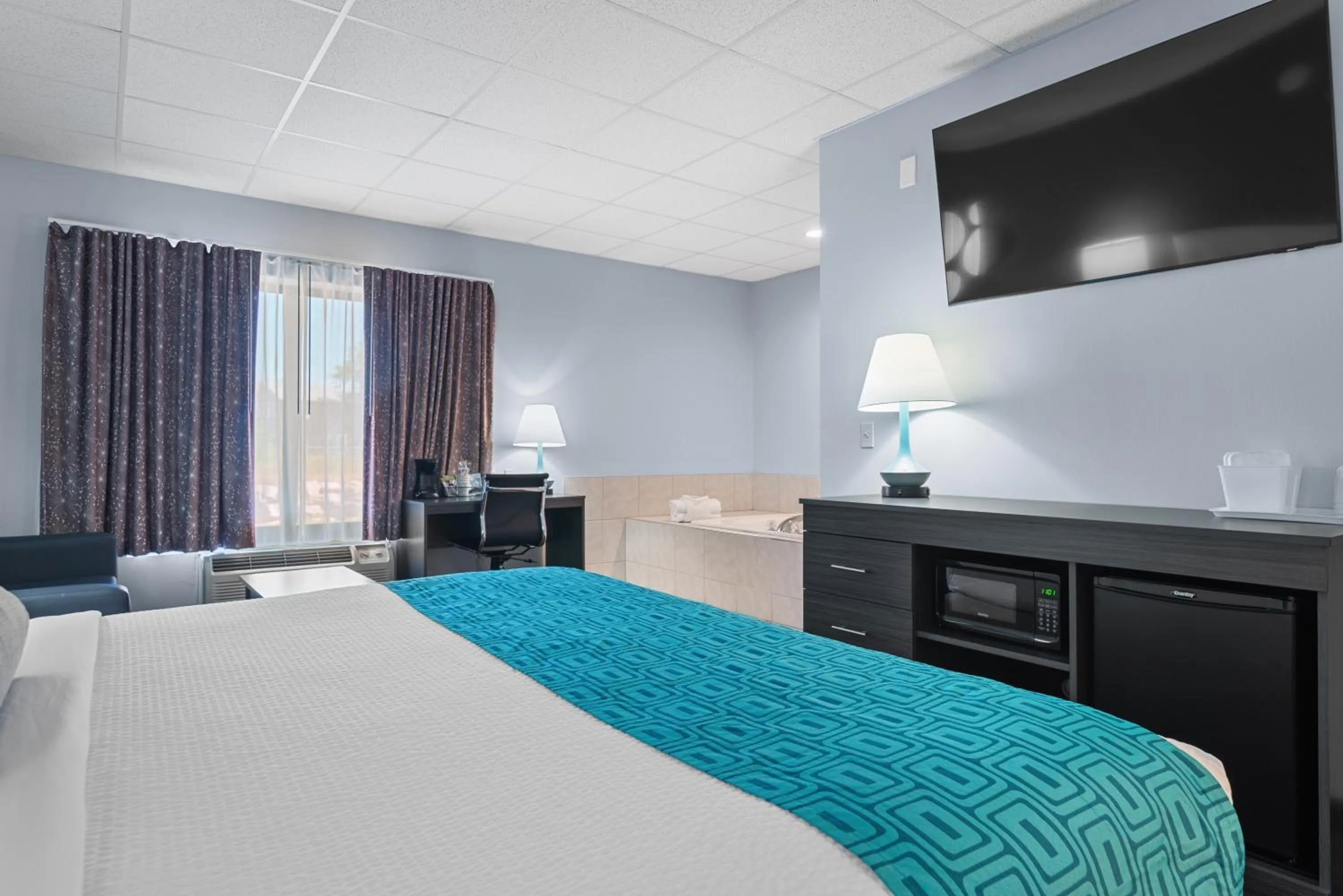 Bed in Elevation Inn & Suites, Trademark Collection by Wyndham