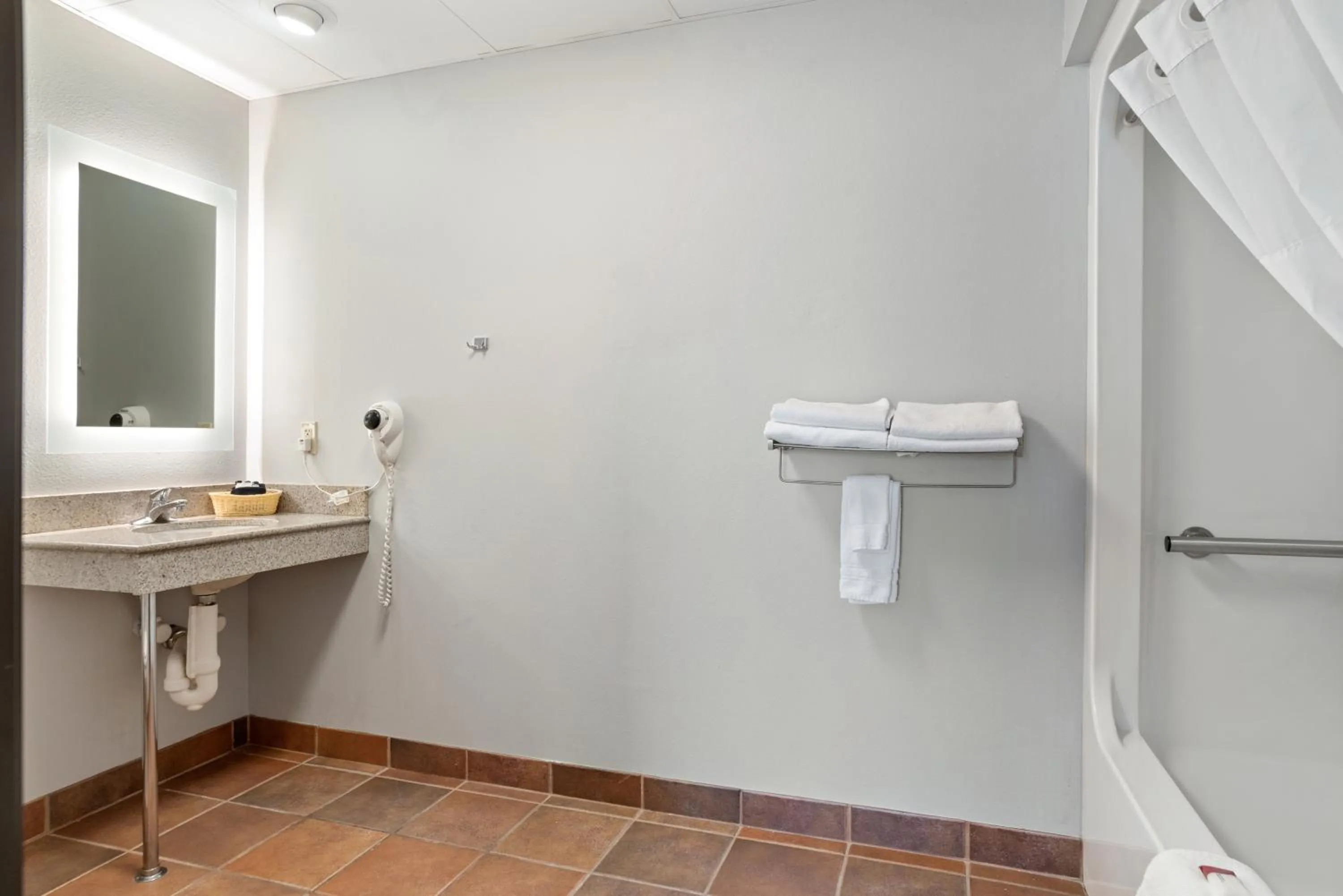 Bathroom in Elevation Inn & Suites, Trademark Collection by Wyndham