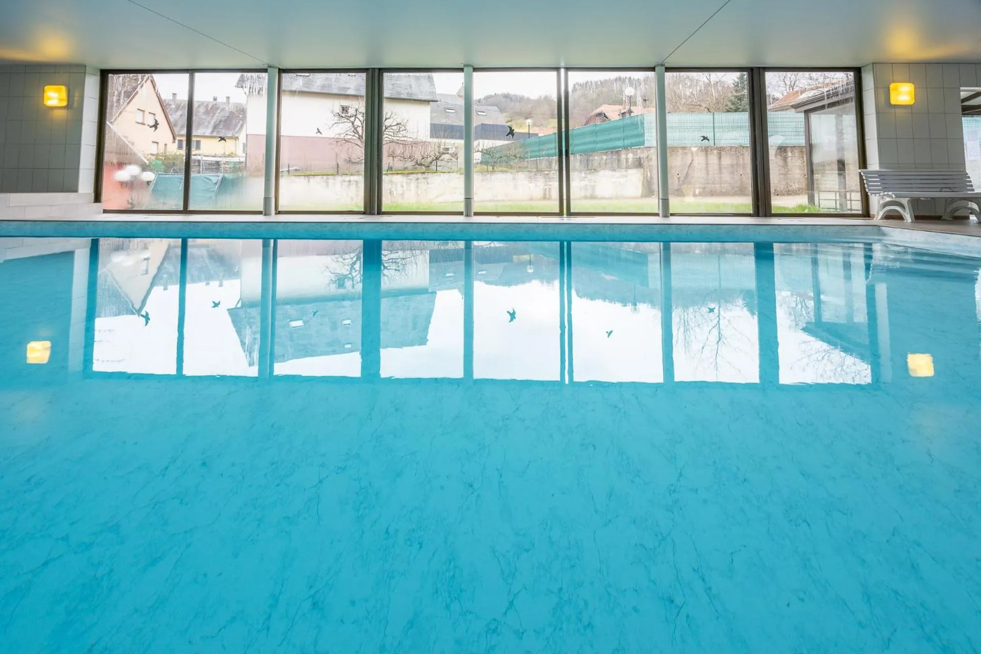 Pool view in Logis Hostellerie Motel Au Bois Le Sire