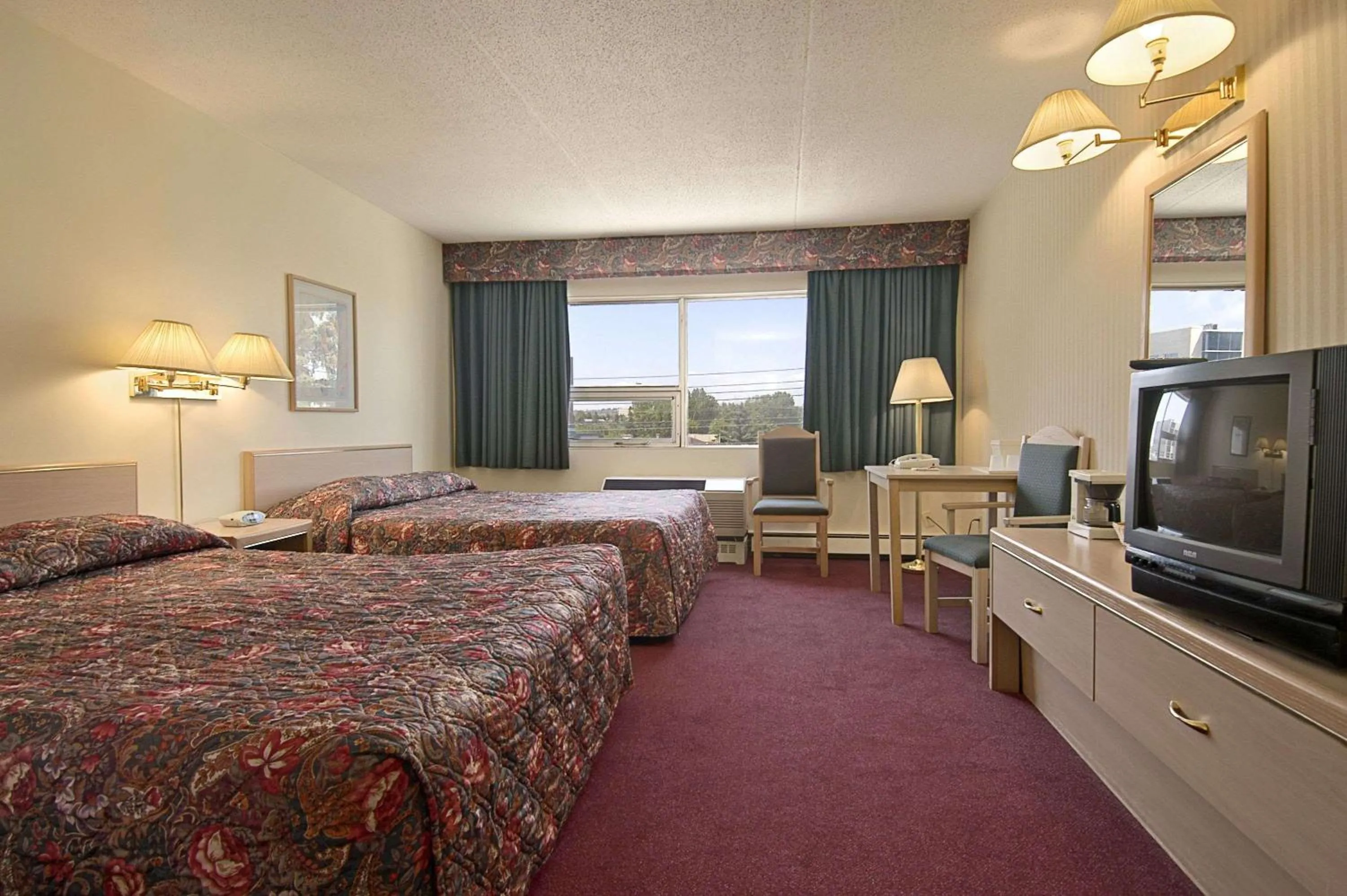 Photo of the whole room, TV/Entertainment Center in Ramada Limited Calgary