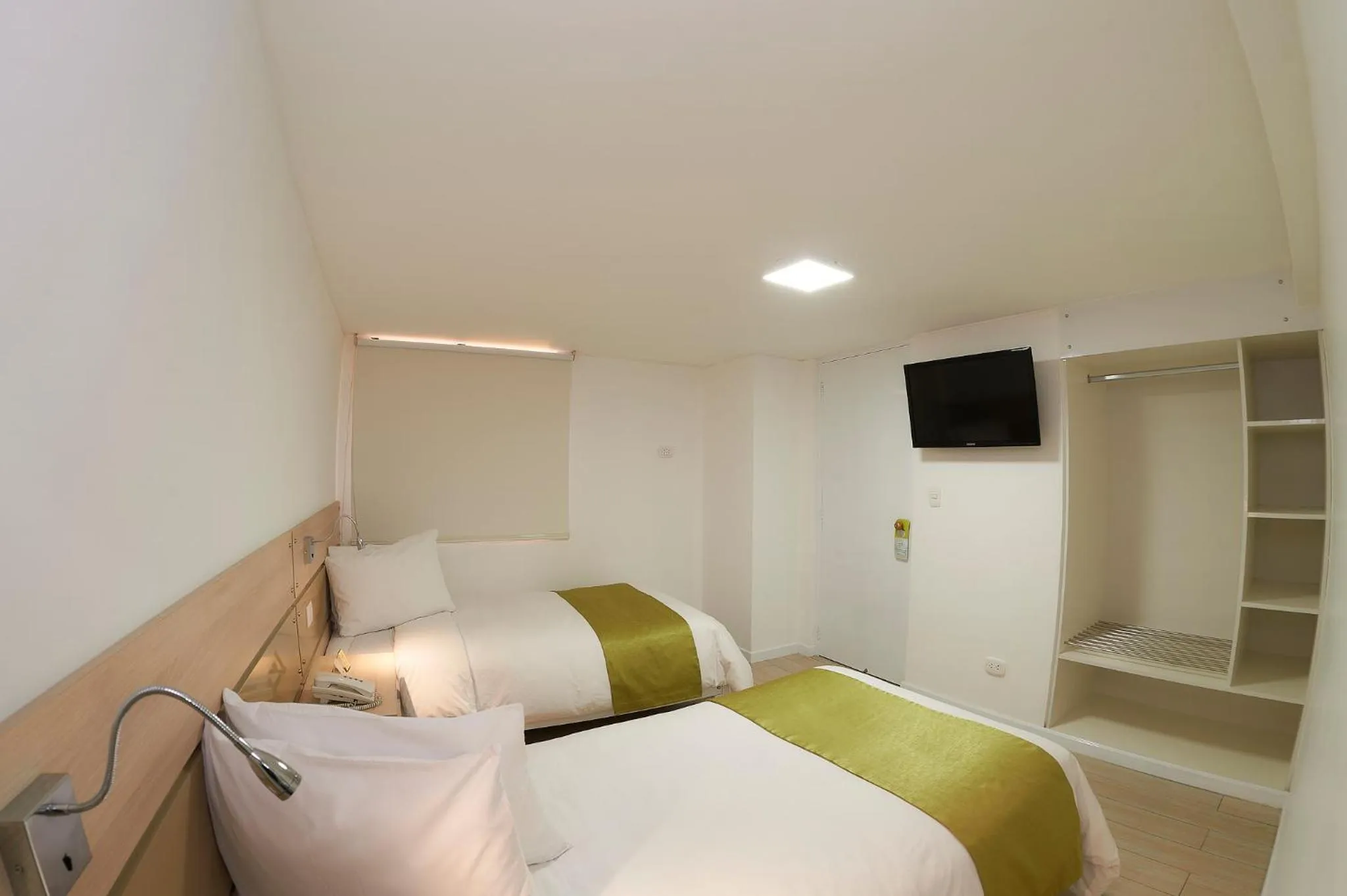 Bed in Natura Inn Hotel