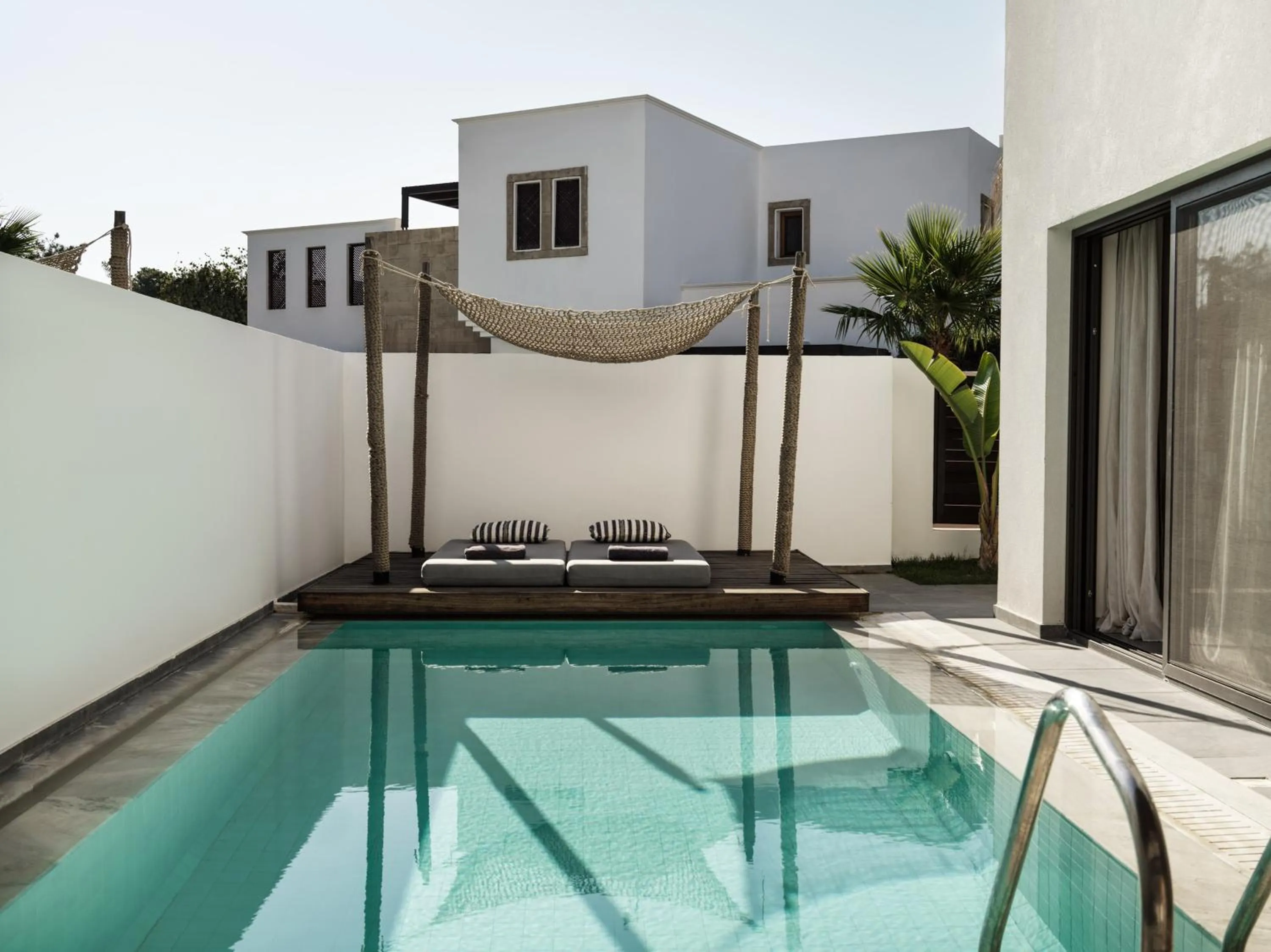 Pool view in Aulūs Lindos Rhodes, Curio Collection by Hilton