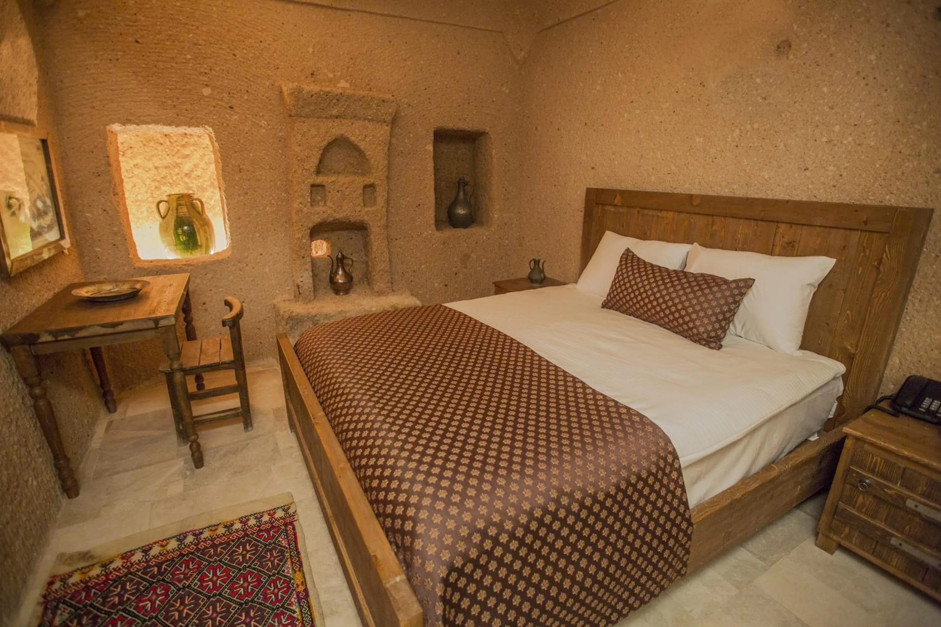Bed in Helike Cave Suites