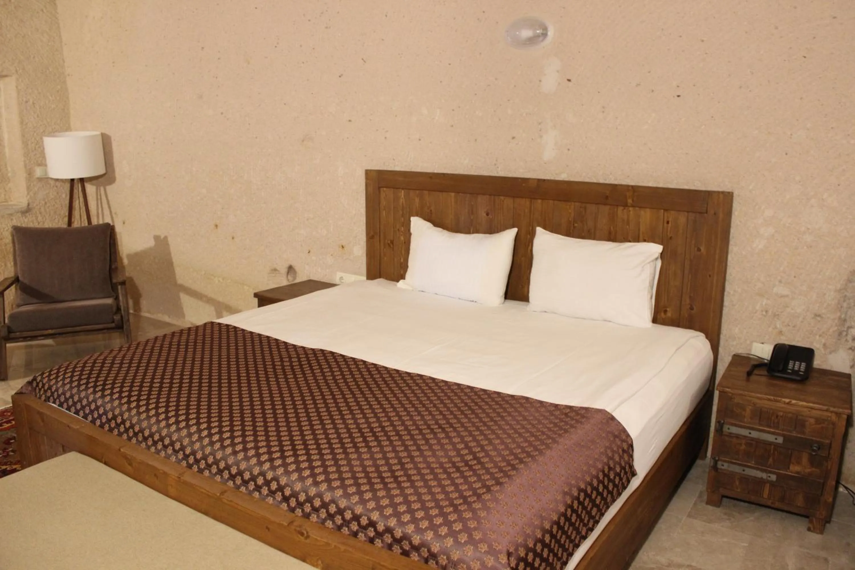 Bed in Helike Cave Suites