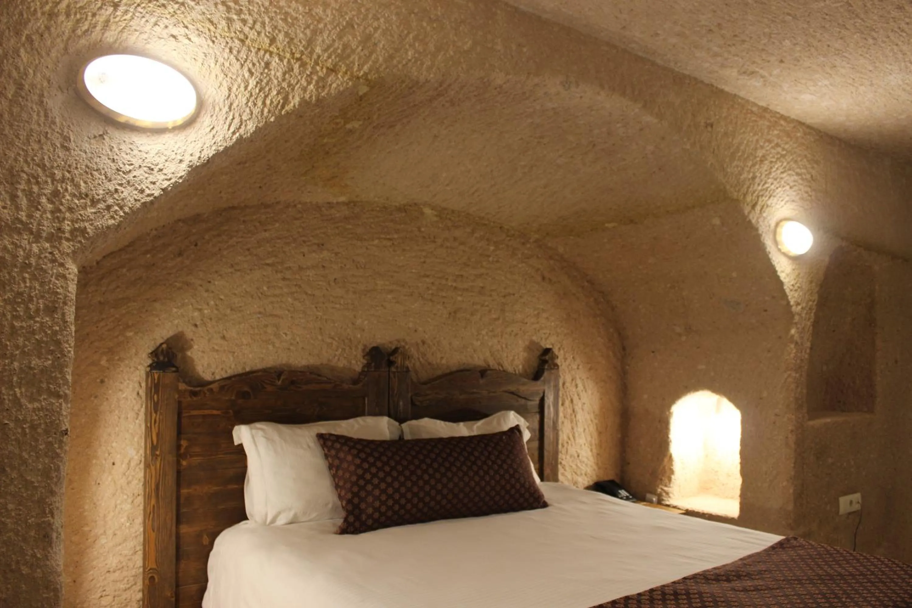 Bed in Helike Cave Suites