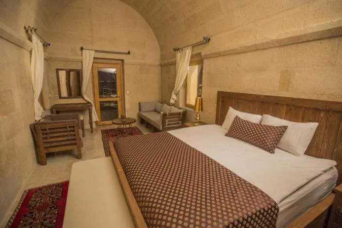 Bed in Helike Cave Suites