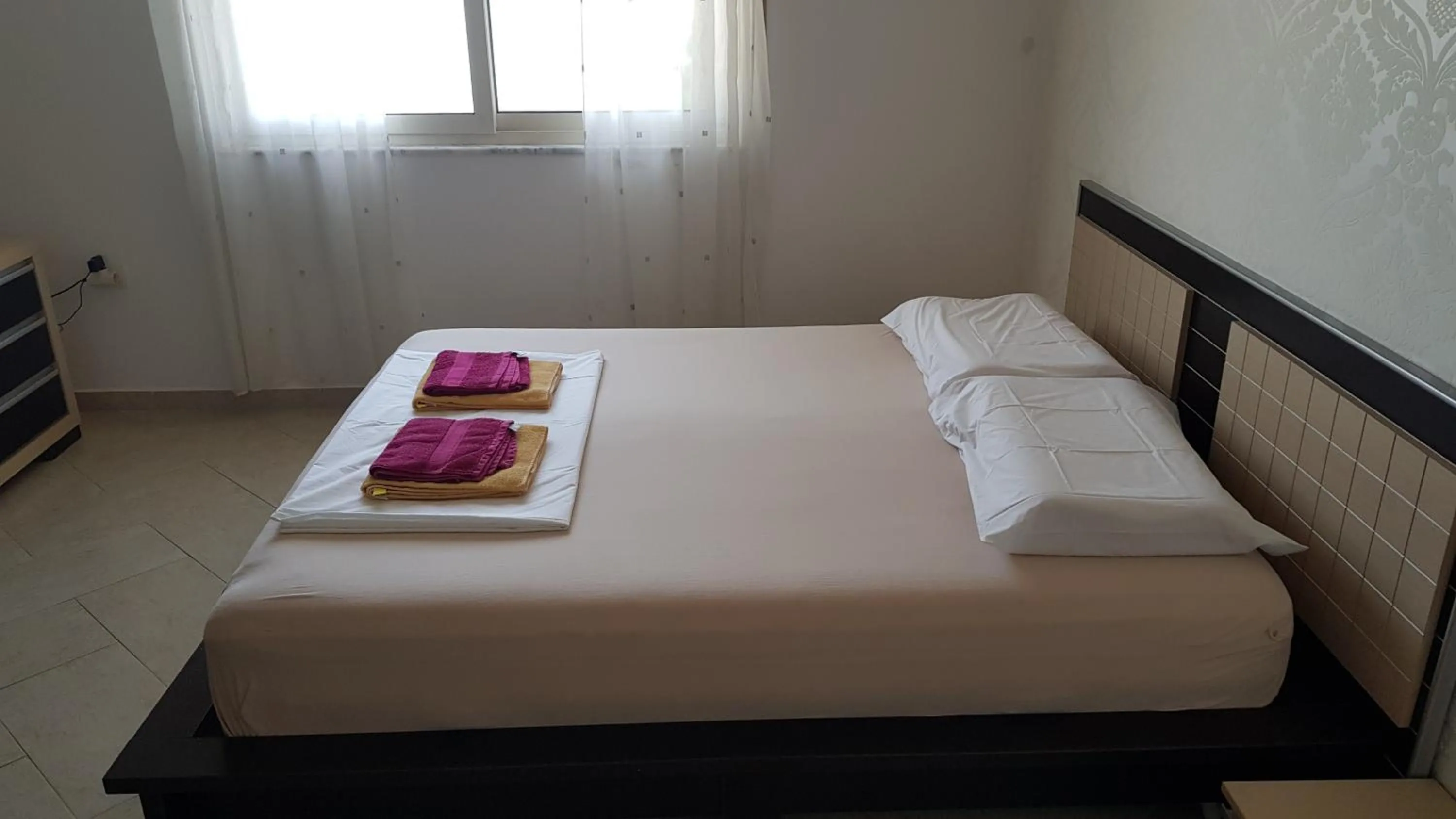 Bed in M&I Beach Apartment with Sea View