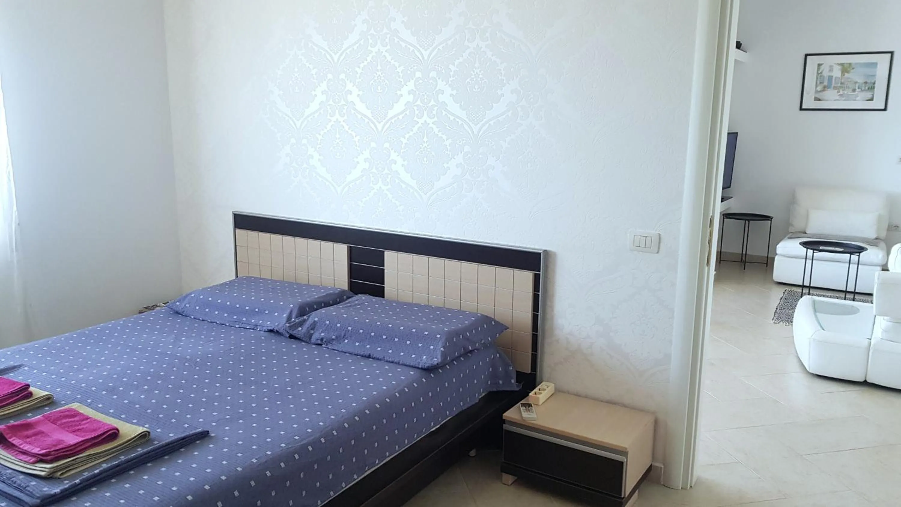 Bed in M&I Beach Apartment with Sea View