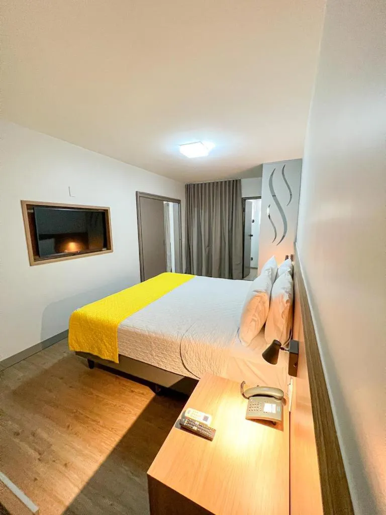 Bed in San Marino Suite Hotel