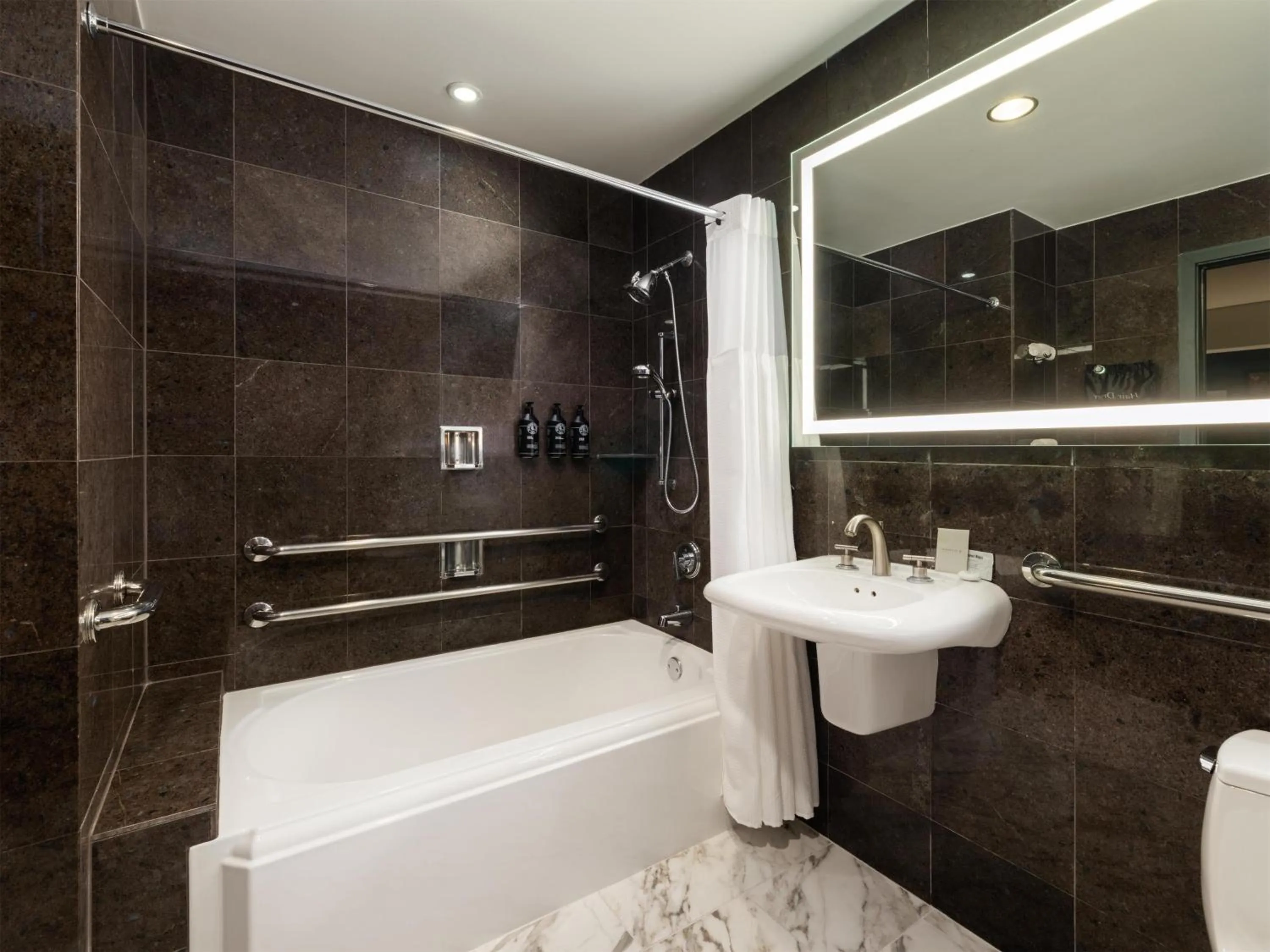 Shower in The Sam Houston Hotel, Curio Collection by Hilton