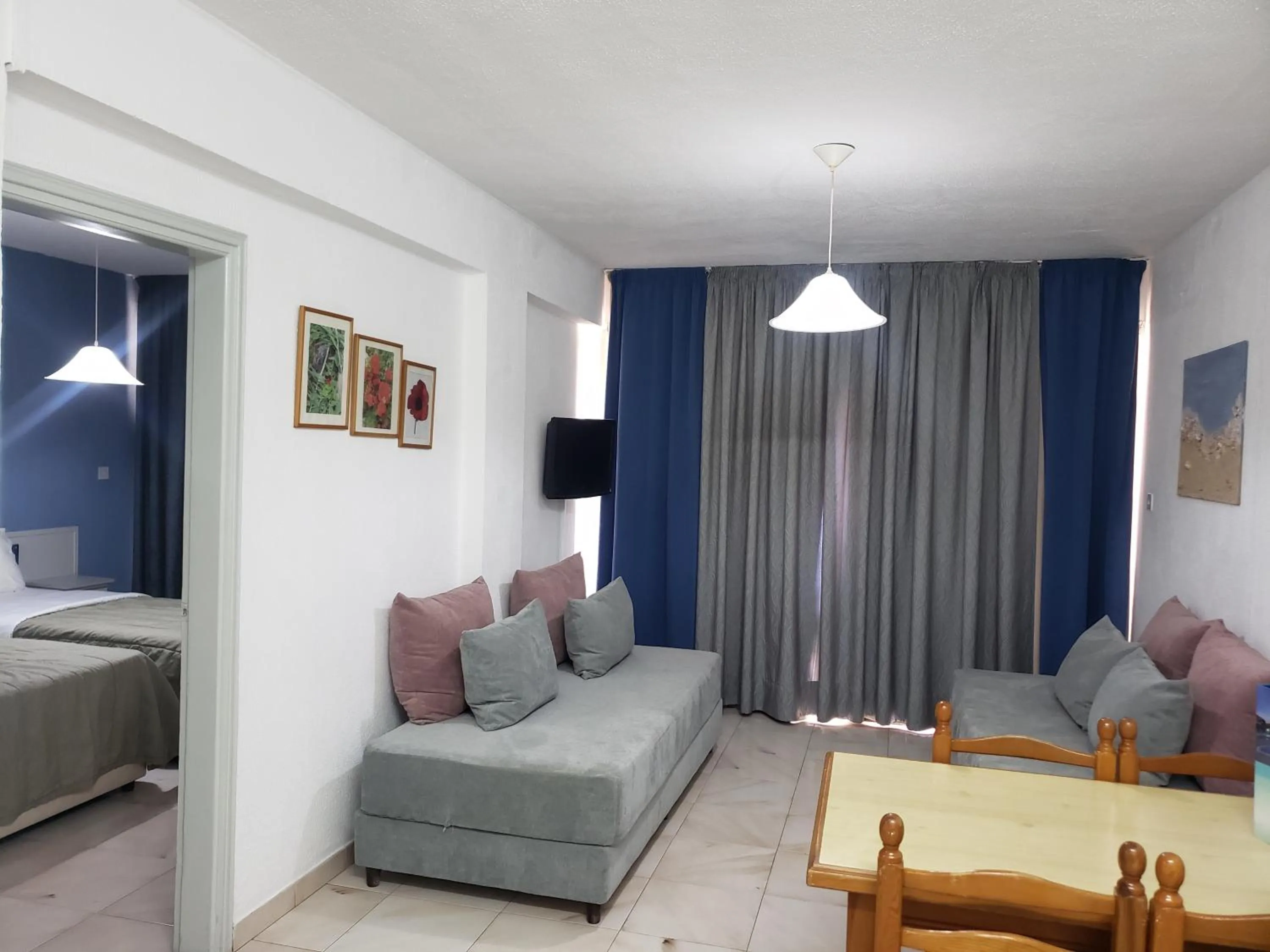 Living room, Bed in Napa Prince Hotel Apts