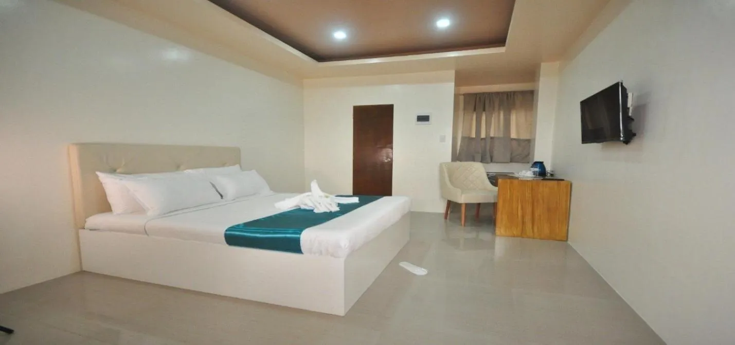 Photo of the whole room, Bed in RNR Suites