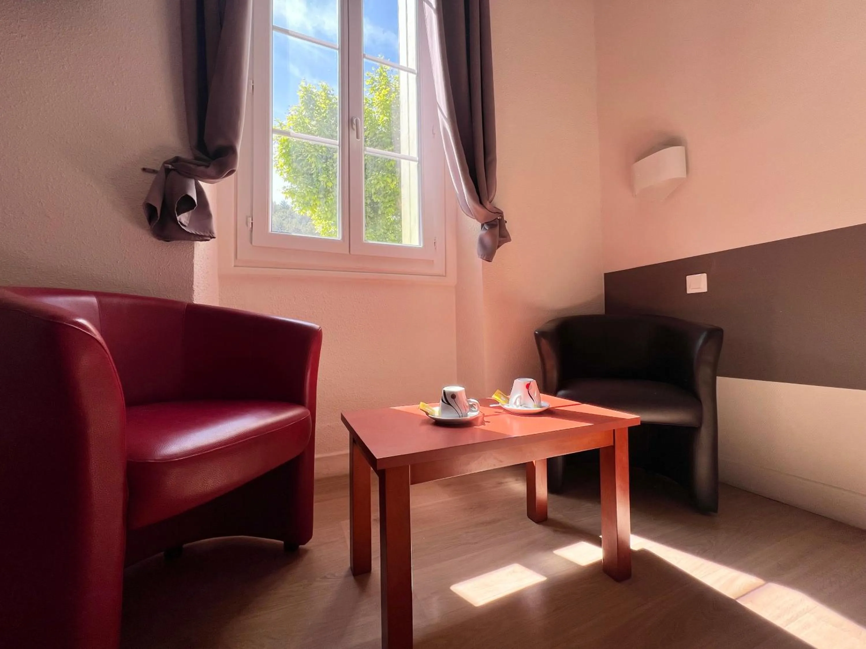 Seating area in Logis Hotel restaurant des Thermes