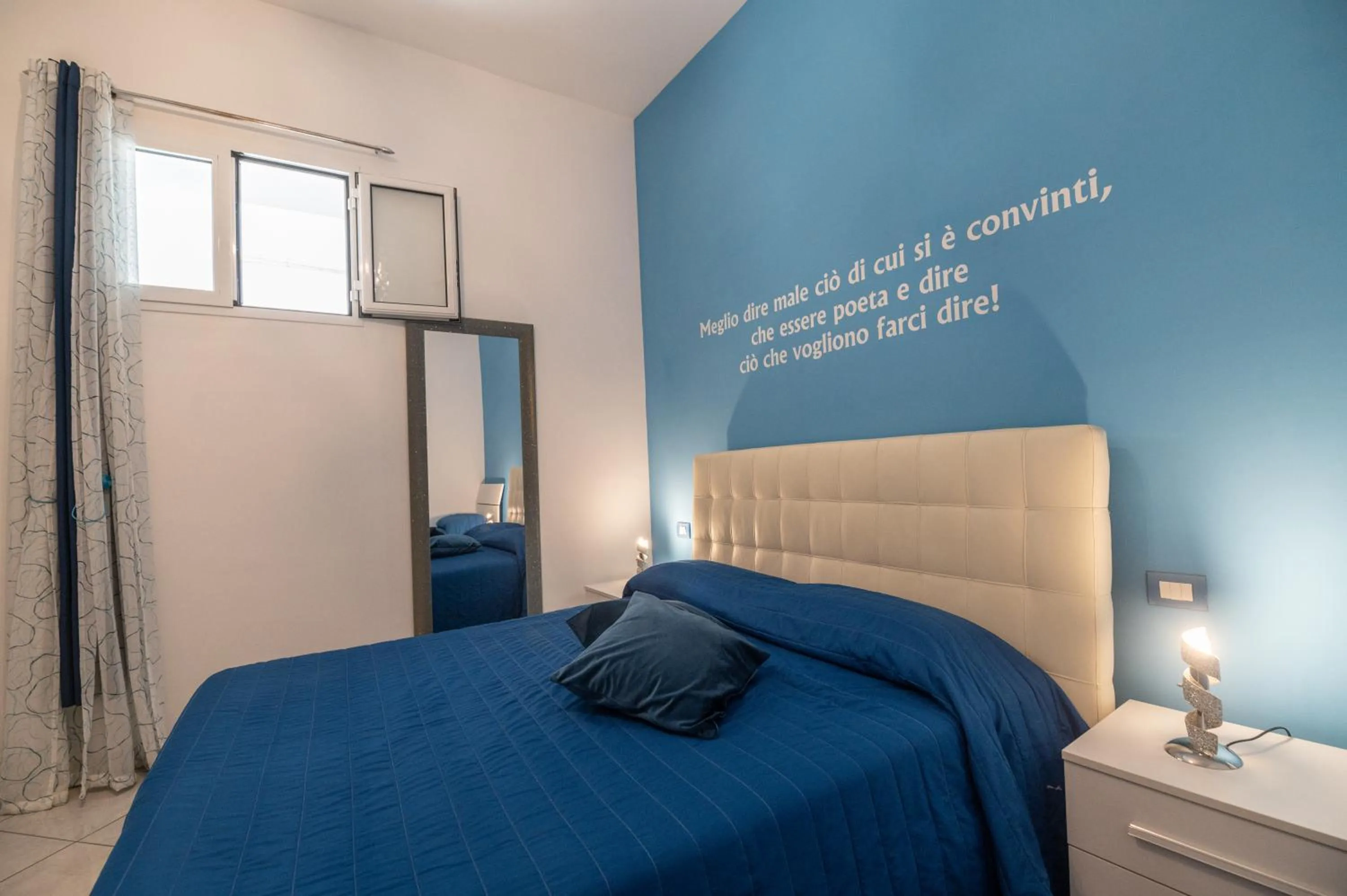 Bed in L'Isola Del Postino Rooms