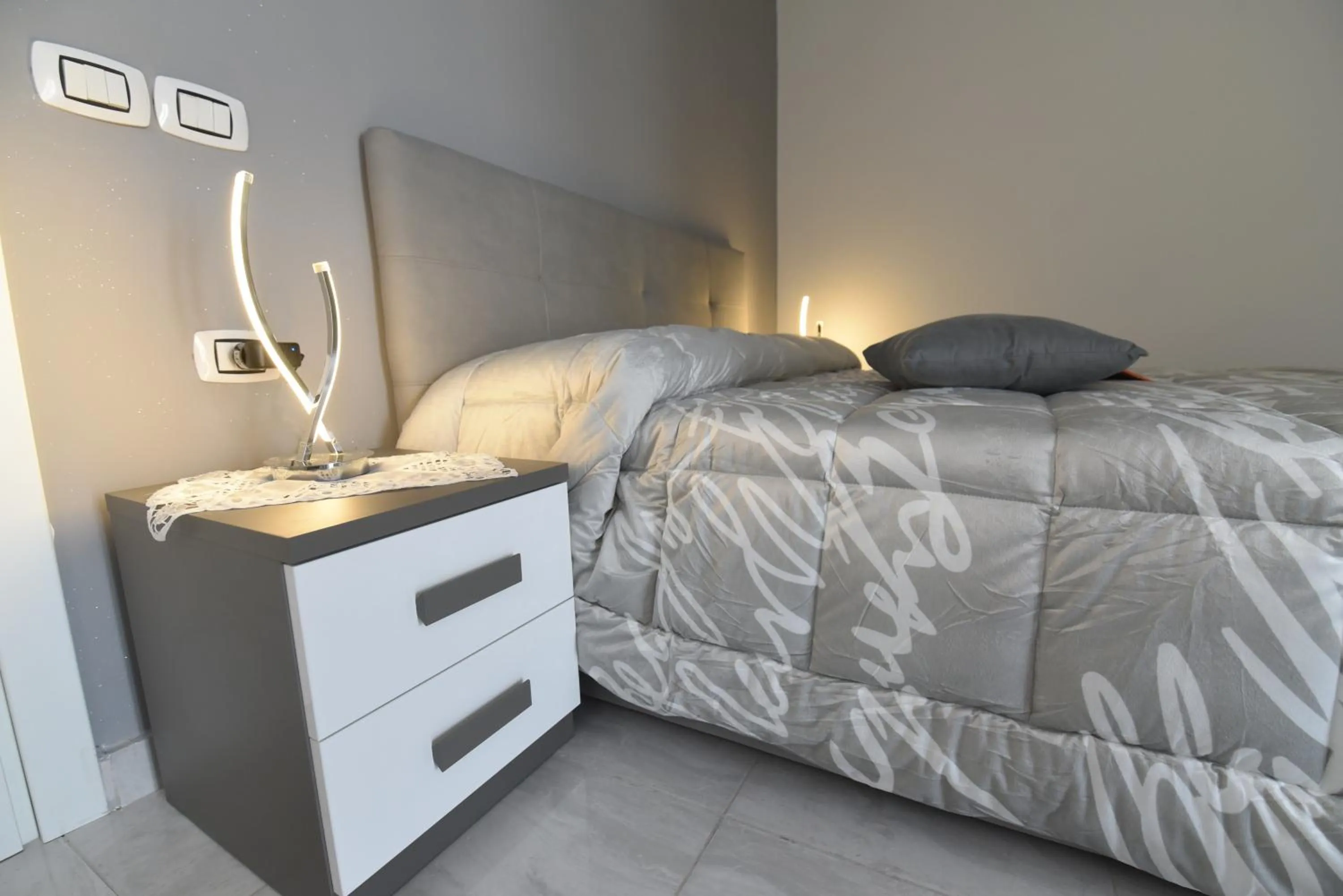 Bed in L'Isola Del Postino Rooms