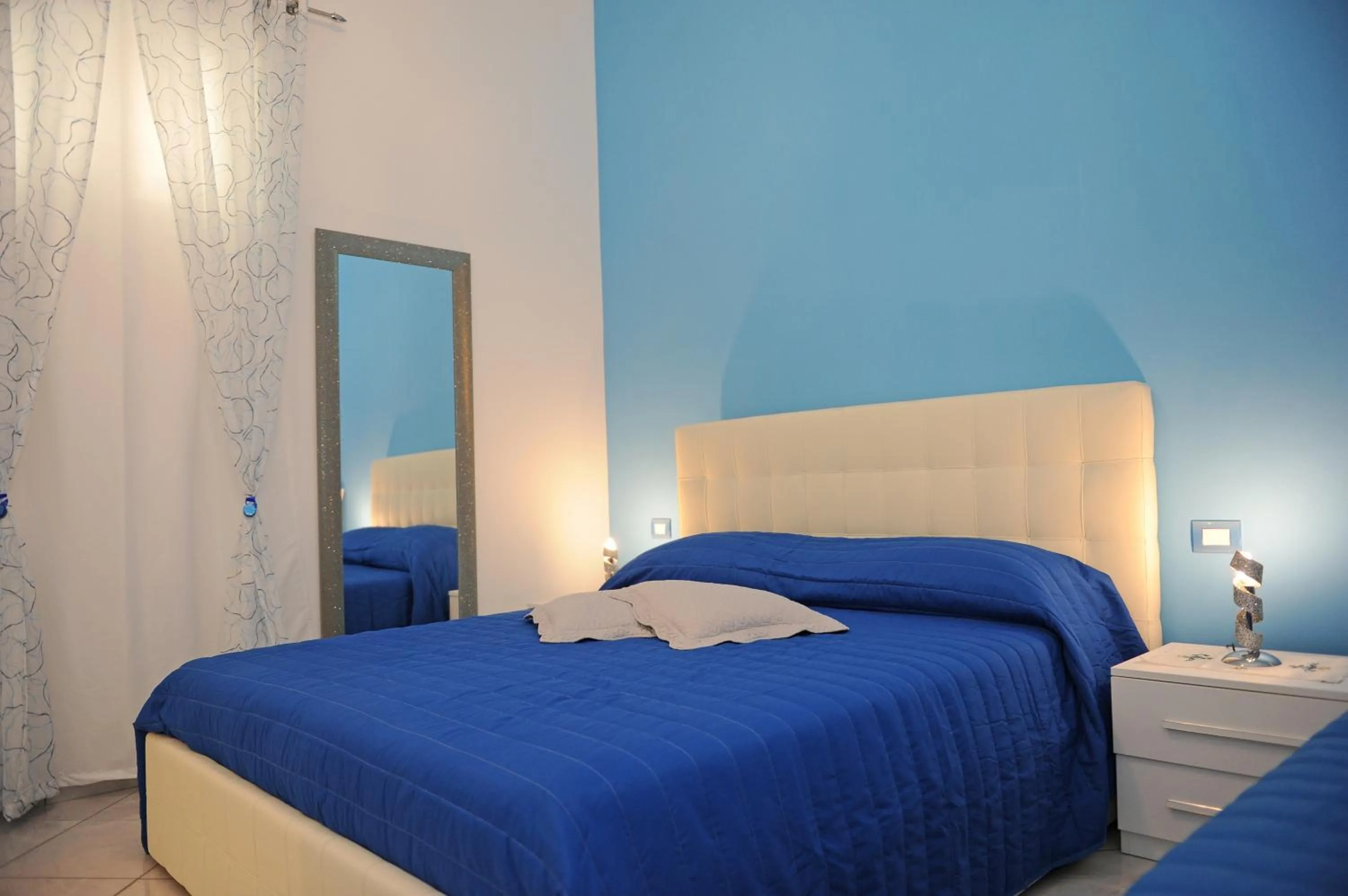 Bed in L'Isola Del Postino Rooms