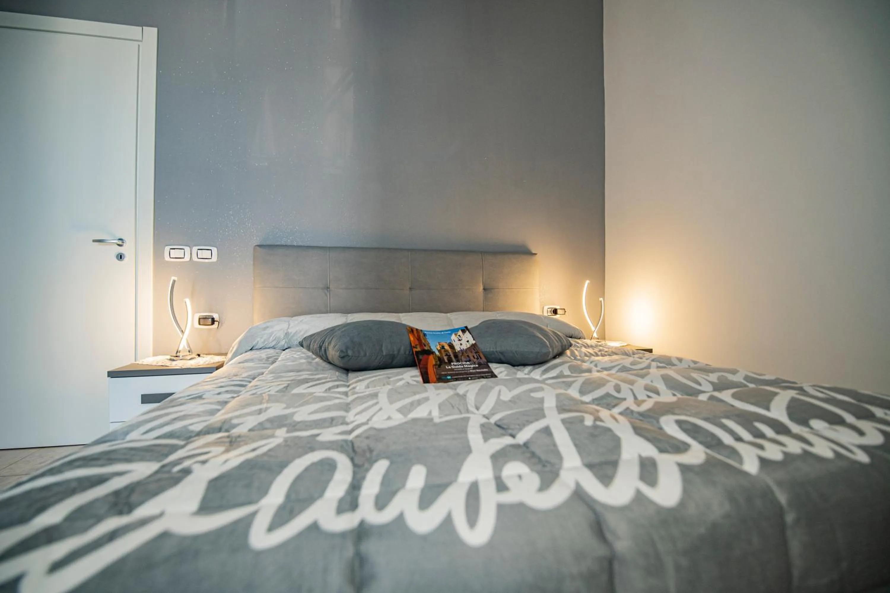 Bed in L'Isola Del Postino Rooms