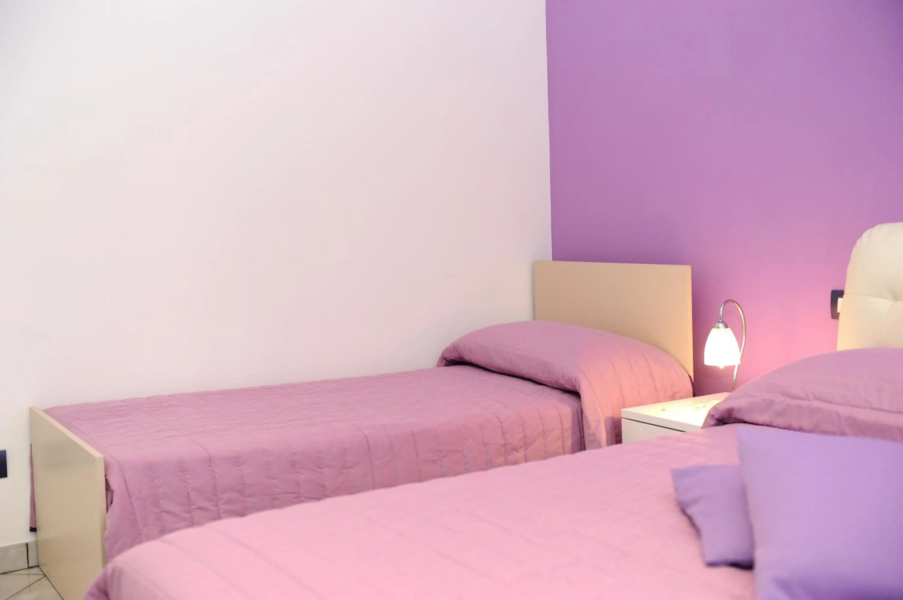 Bed in L'Isola Del Postino Rooms