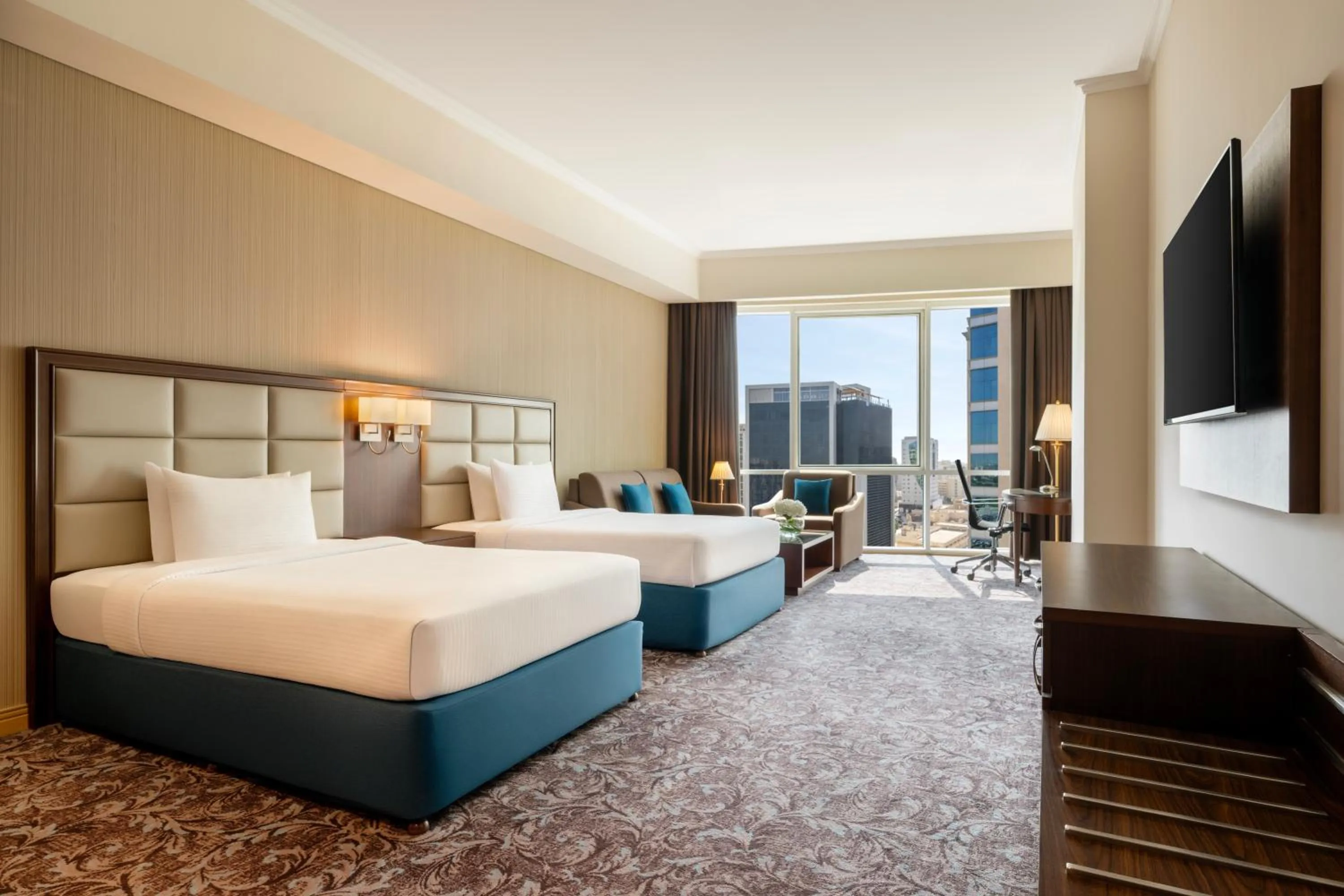 Communal lounge/ TV room, Bed in Golden Tulip Doha Hotel