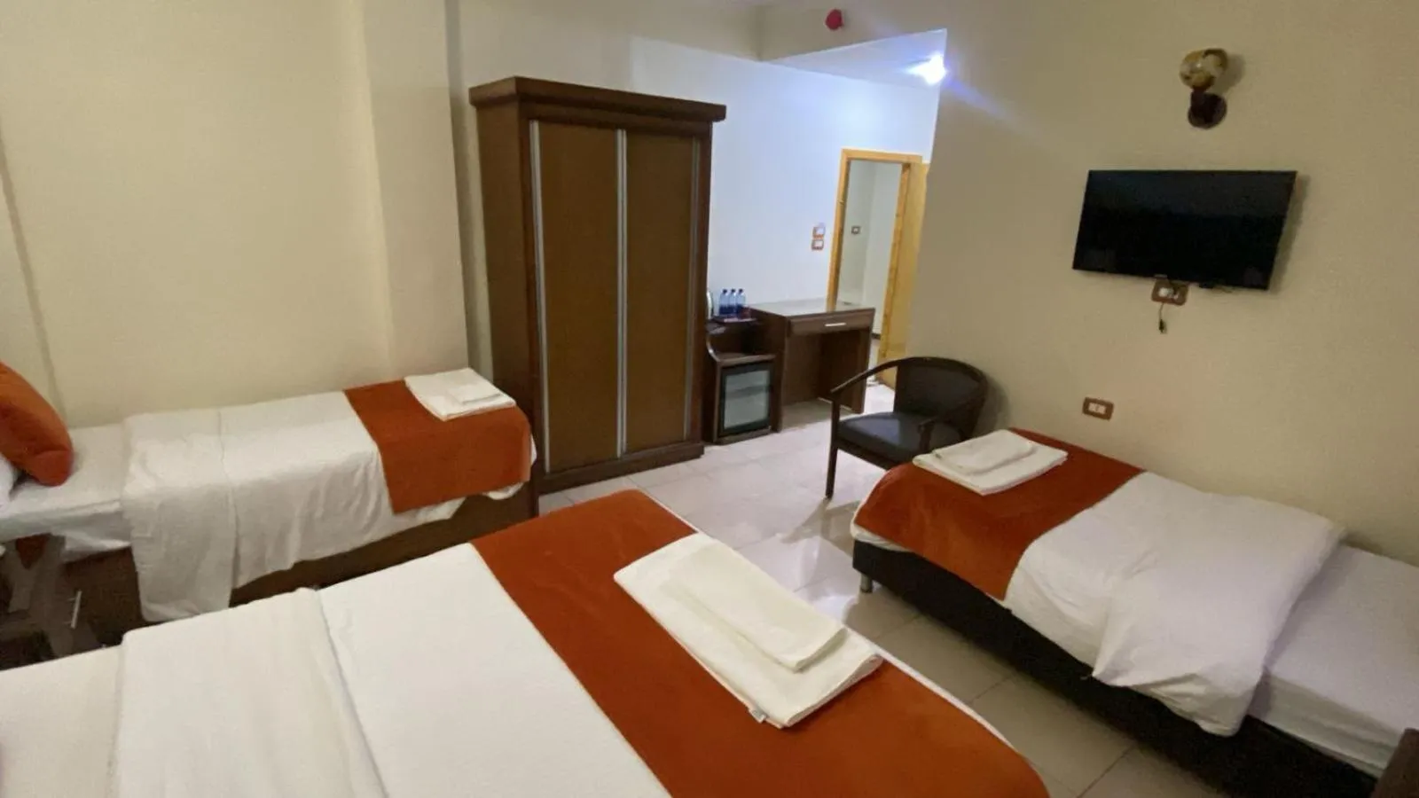 Communal lounge/ TV room, Bed in Sunset Hotel