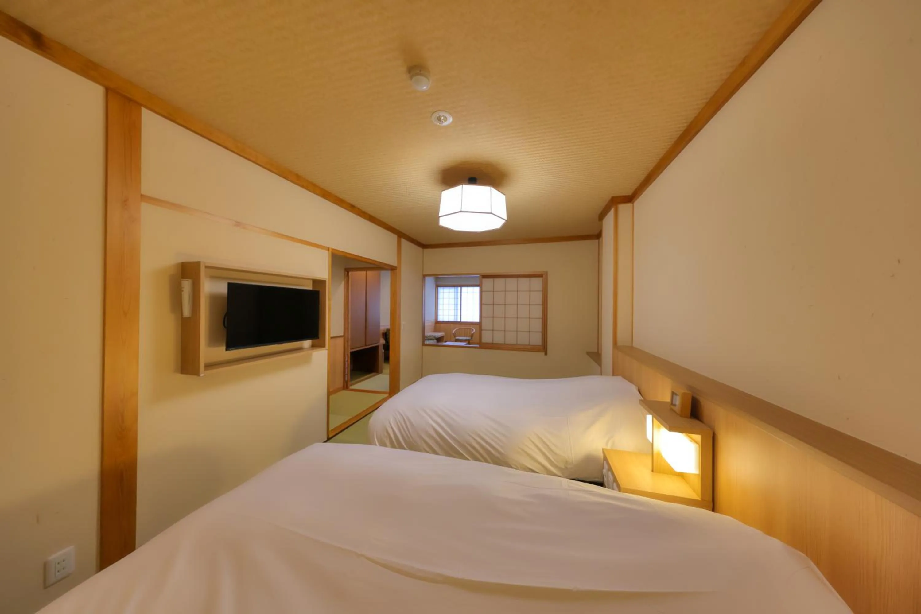 Bed in Miyama Ouan Kyoritsu Resort