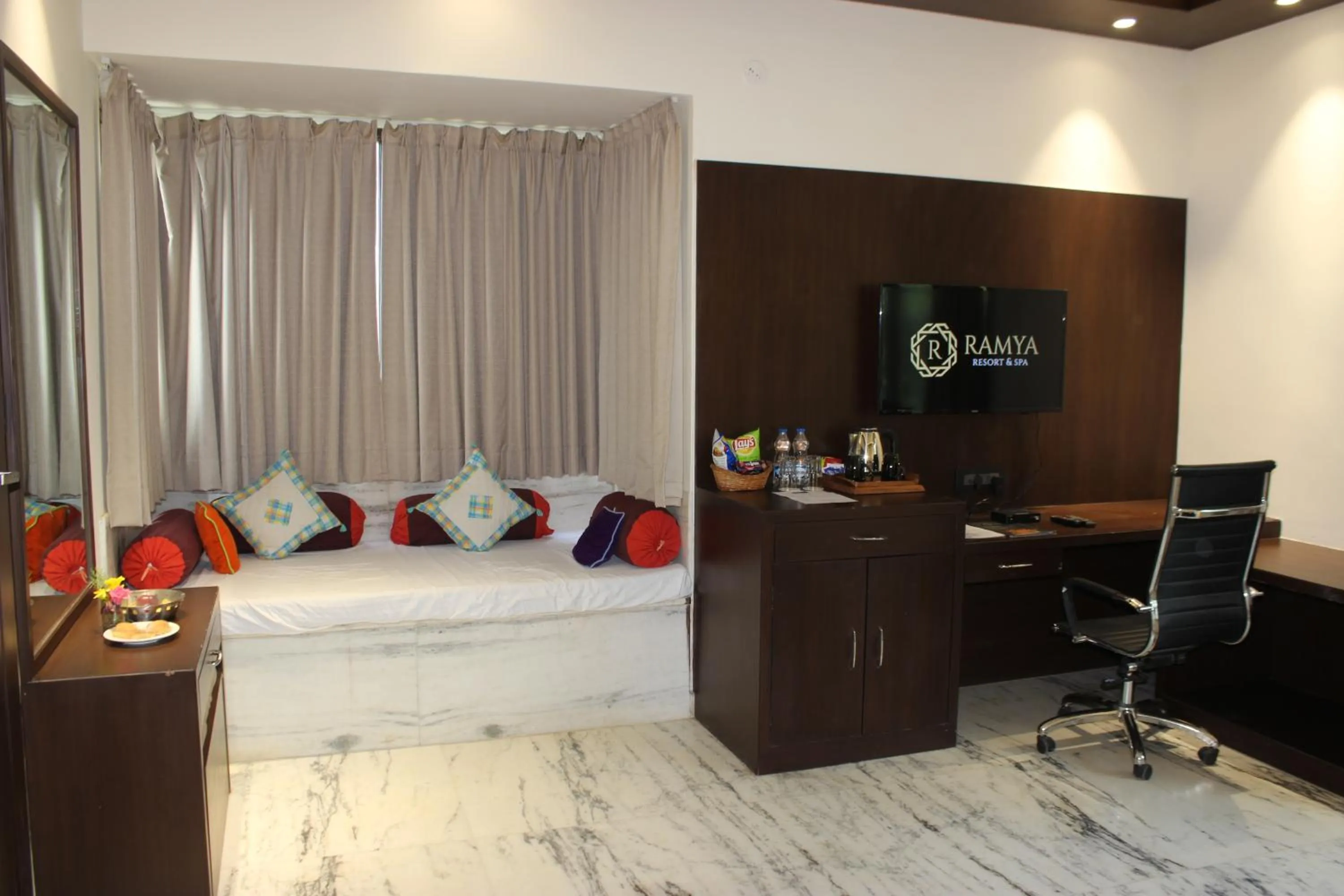 Communal lounge/ TV room, Bed in Ramya Resort & Spa