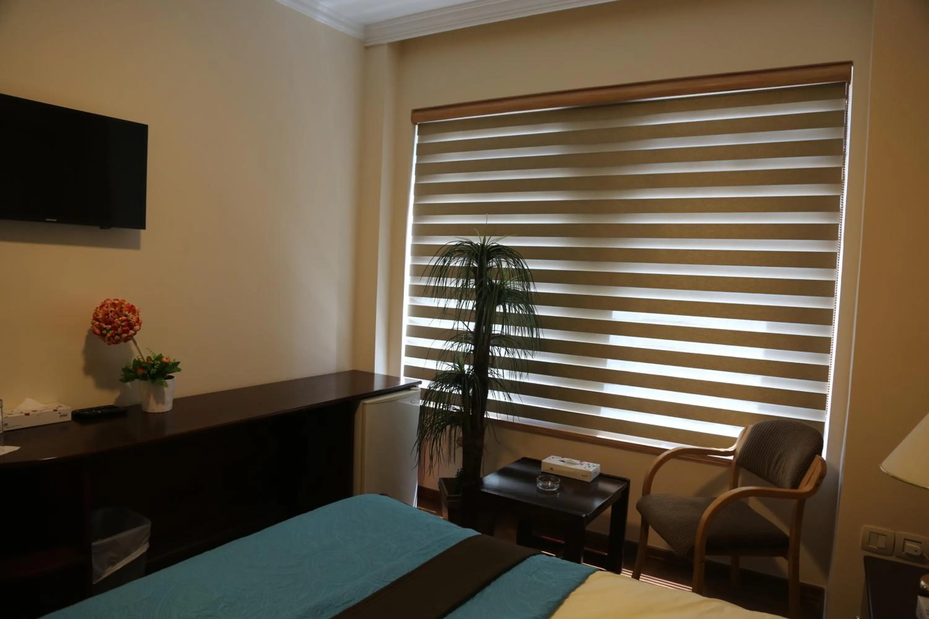 Seating area, Bed in Rozana Hotel