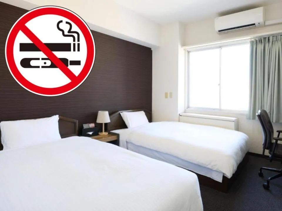 Bed in Tabist HotelArflex Tokuyama Station