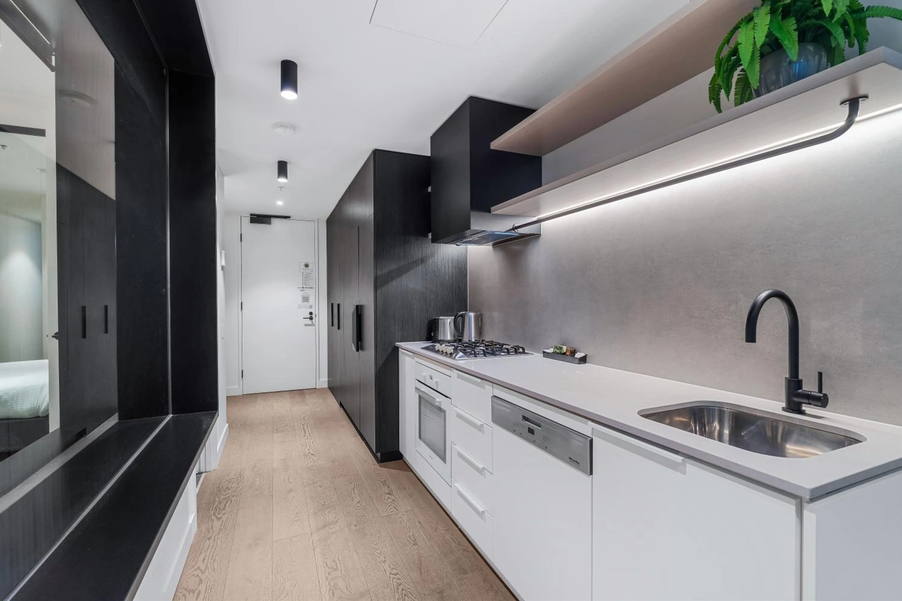 Kitchen or kitchenette in The Eminence Apartments by CLLIX