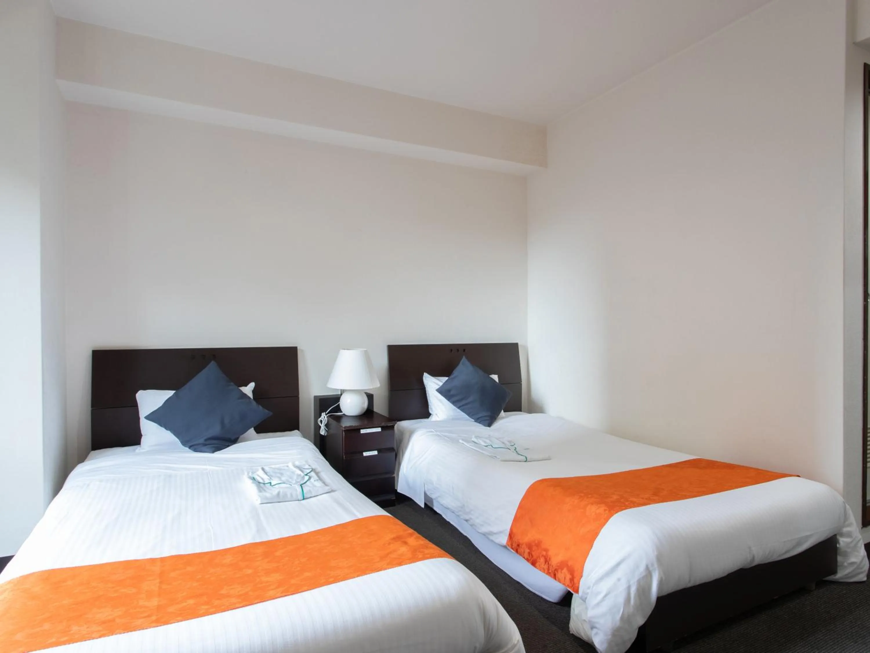 Bed in Tabist Sasebo Palace Hotel