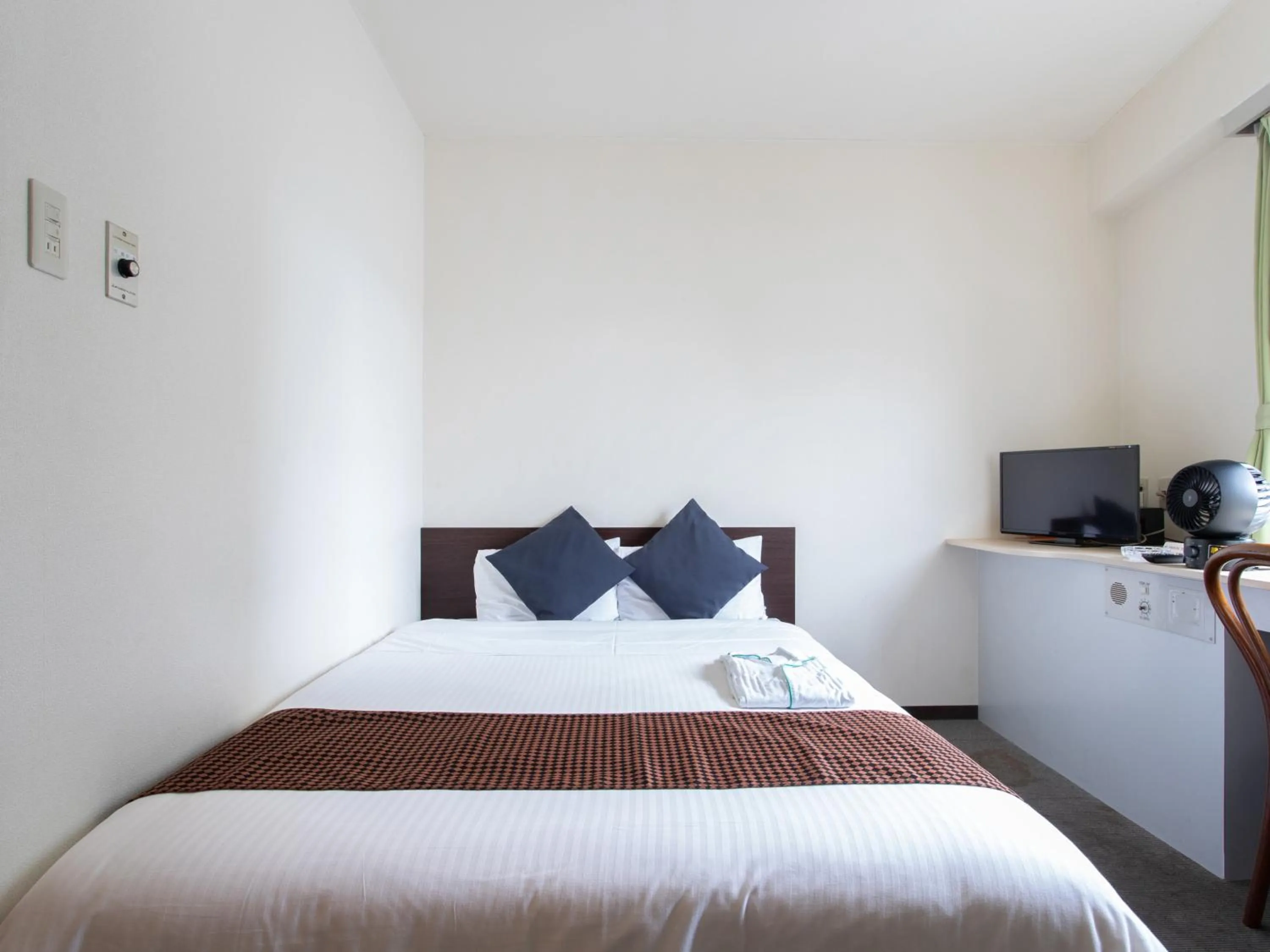 Bed in Tabist Sasebo Palace Hotel