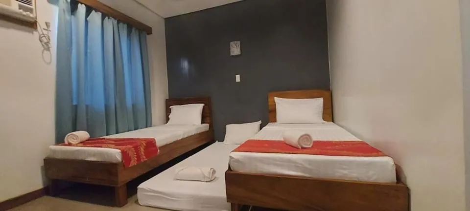 Bed in Acacia Garden Inn and Suites