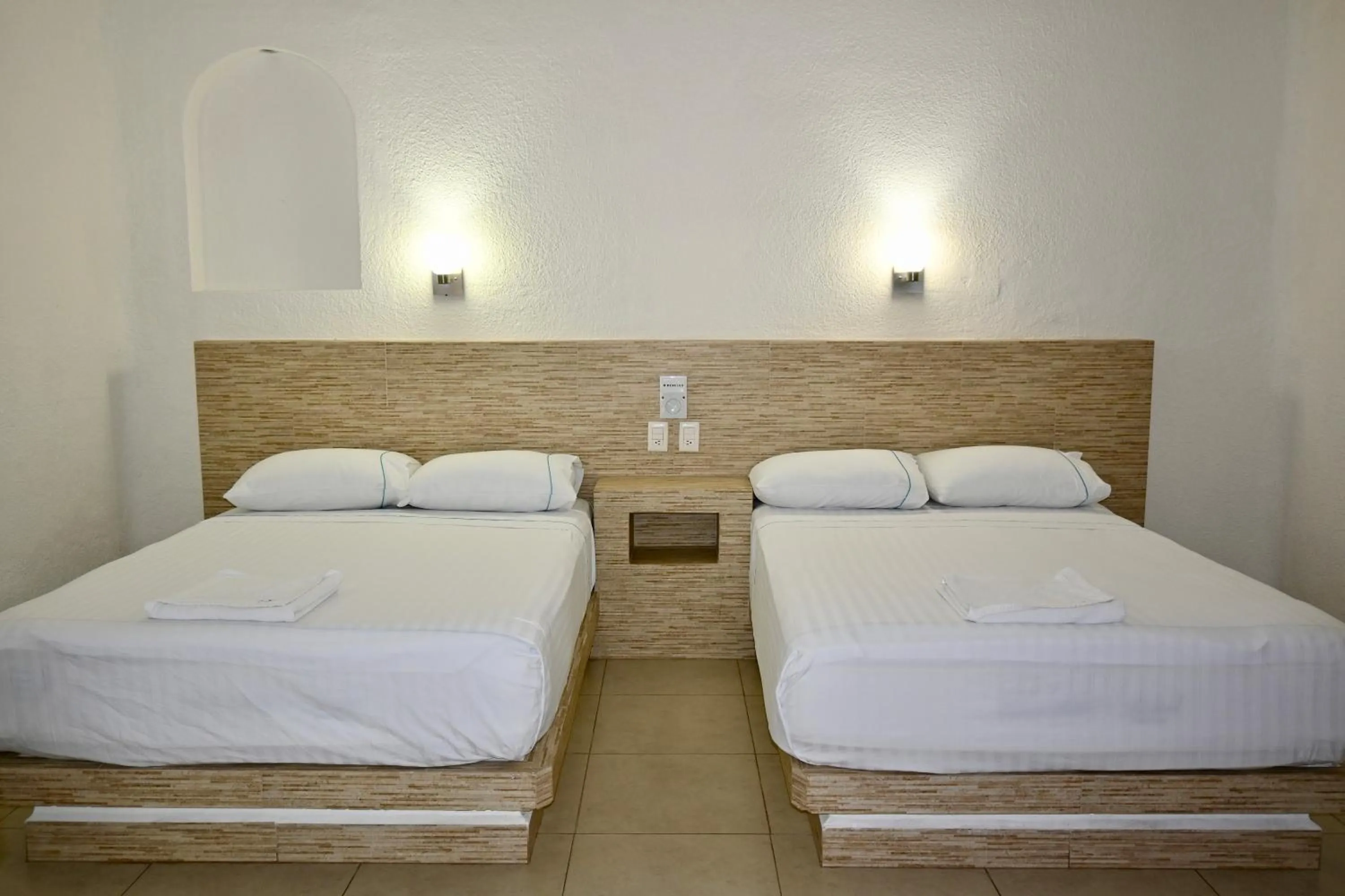 Bed in Pelicano Inn Playa del Carmen - Beachfront Hotel