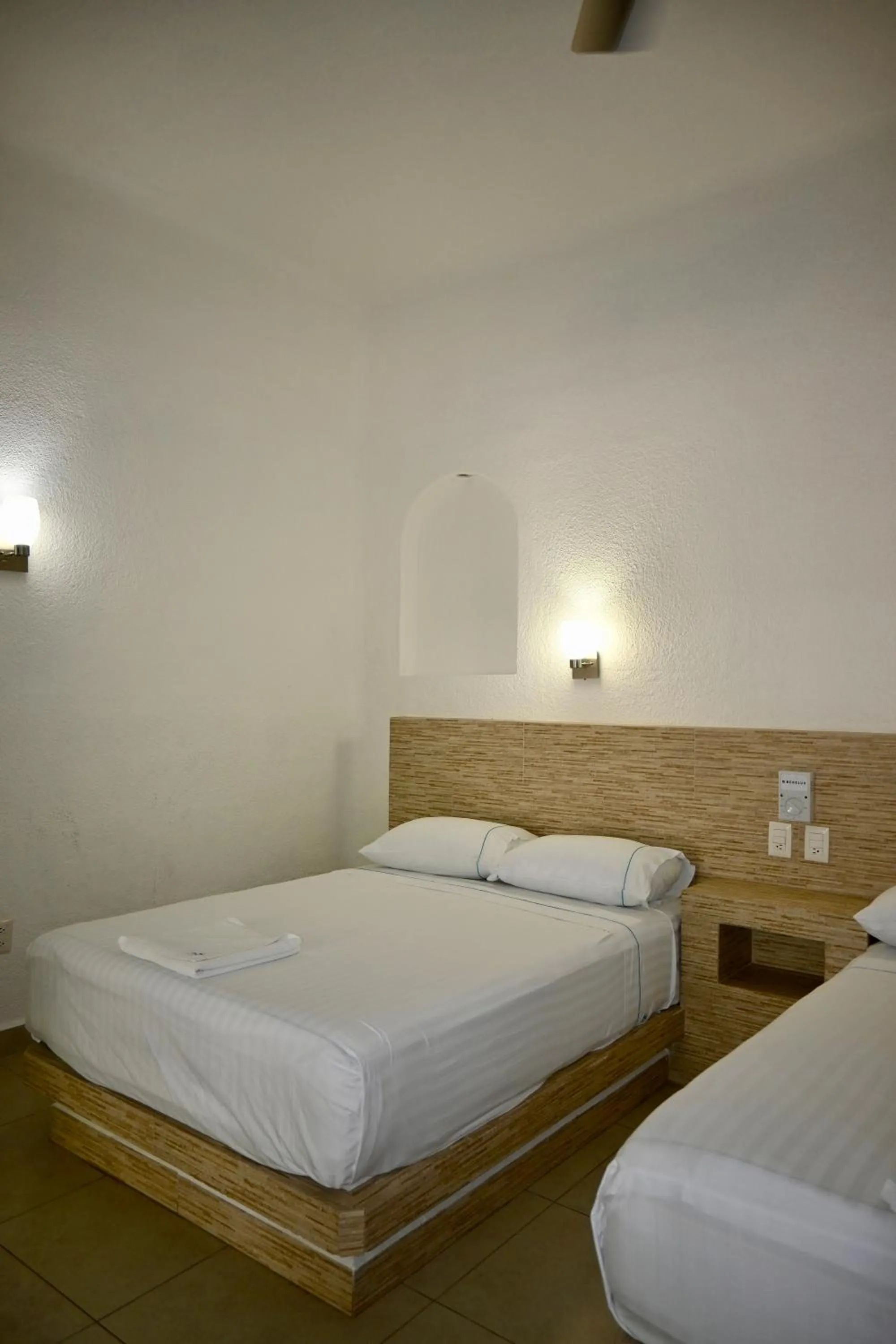 Bed in Pelicano Inn Playa del Carmen - Beachfront Hotel