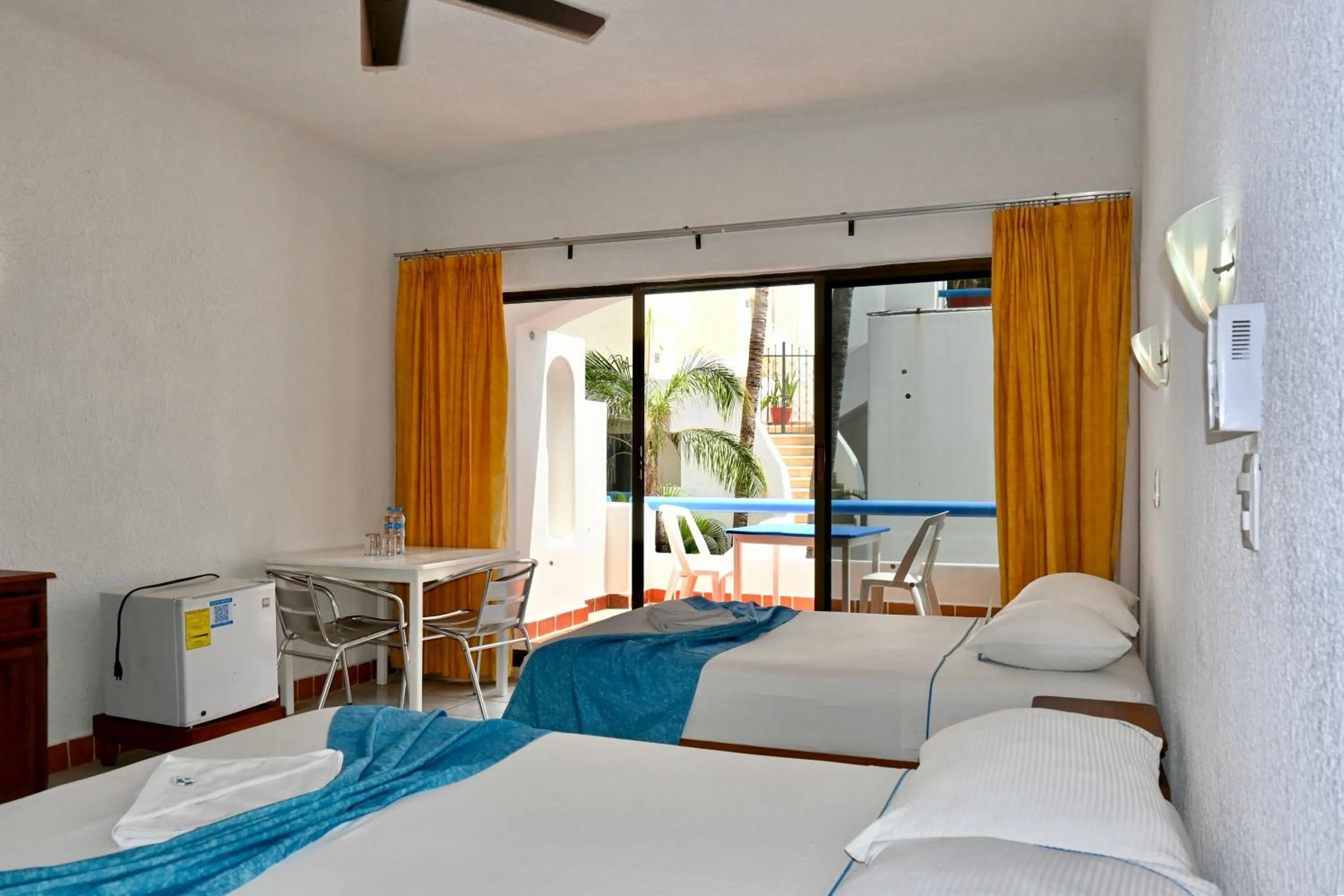 Bed in Pelicano Inn Playa del Carmen - Beachfront Hotel