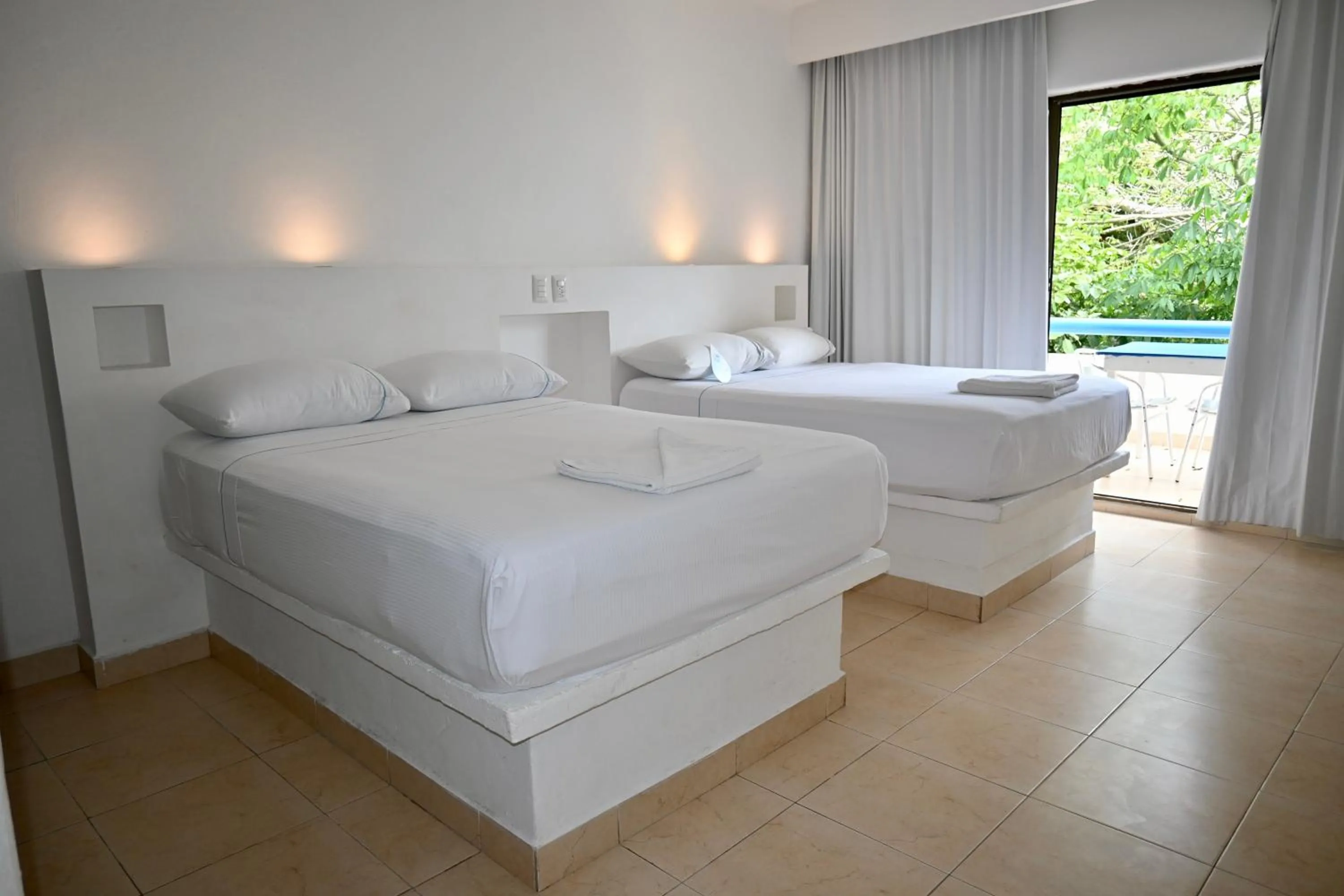 Bed in Pelicano Inn Playa del Carmen - Beachfront Hotel