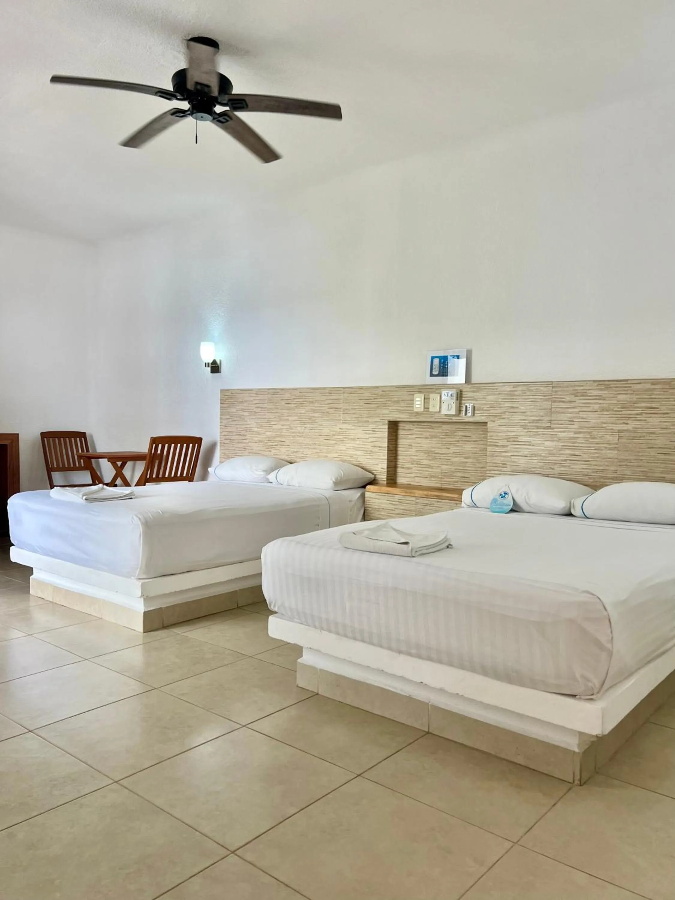 Bed in Pelicano Inn Playa del Carmen - Beachfront Hotel