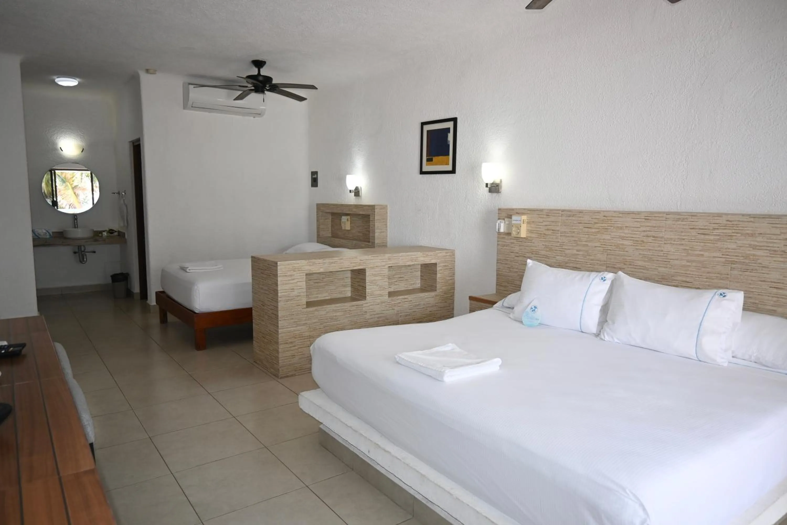 Bed in Pelicano Inn Playa del Carmen - Beachfront Hotel