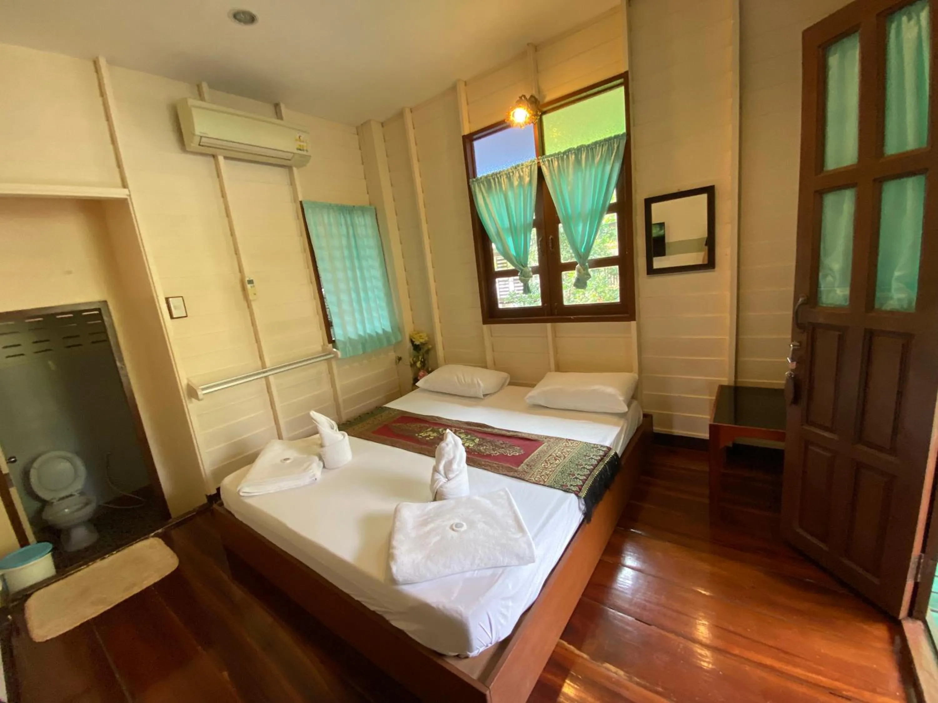 Bed in บ้านกรนรา Baan Kornnara