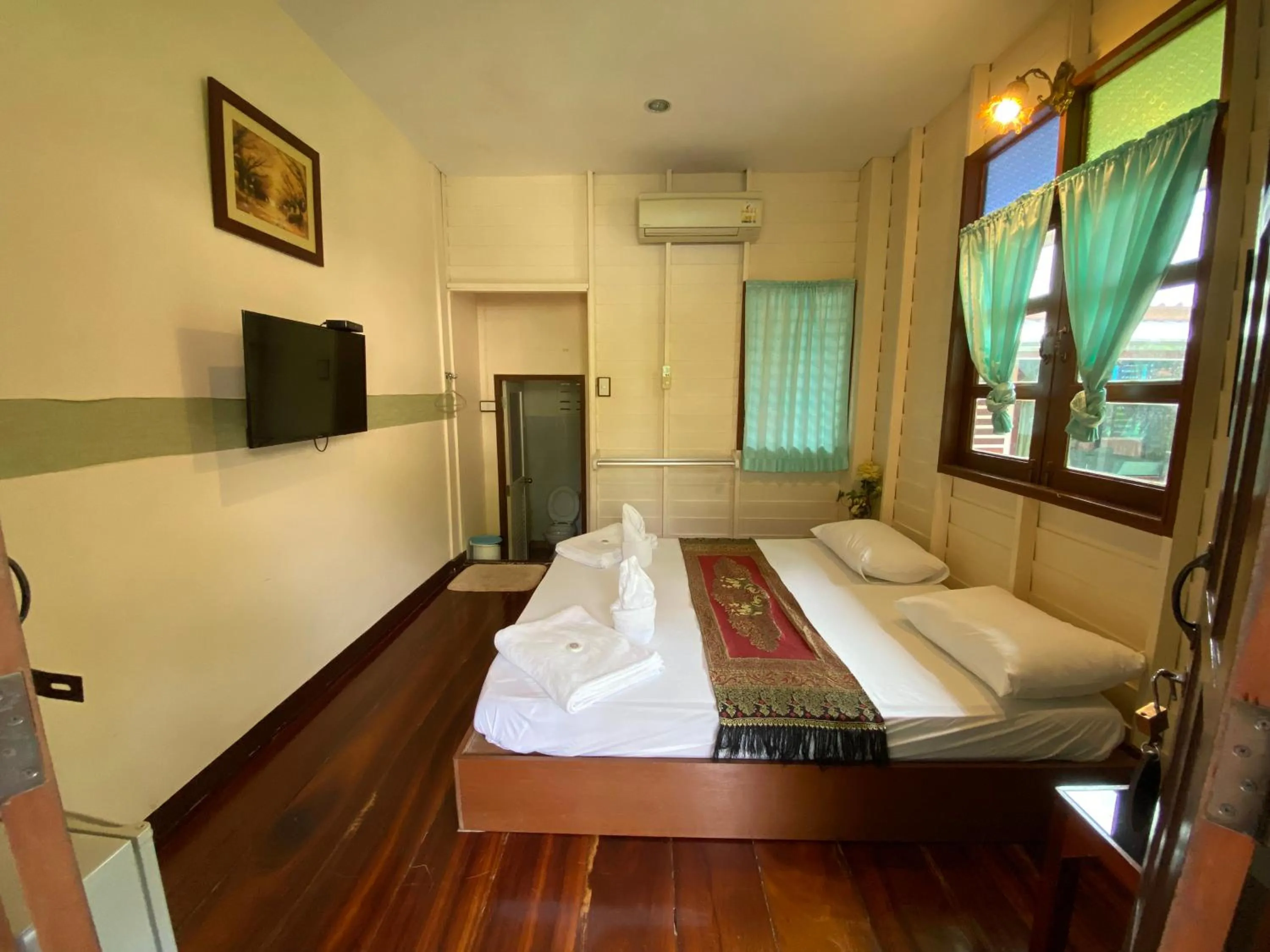 Bed in บ้านกรนรา Baan Kornnara