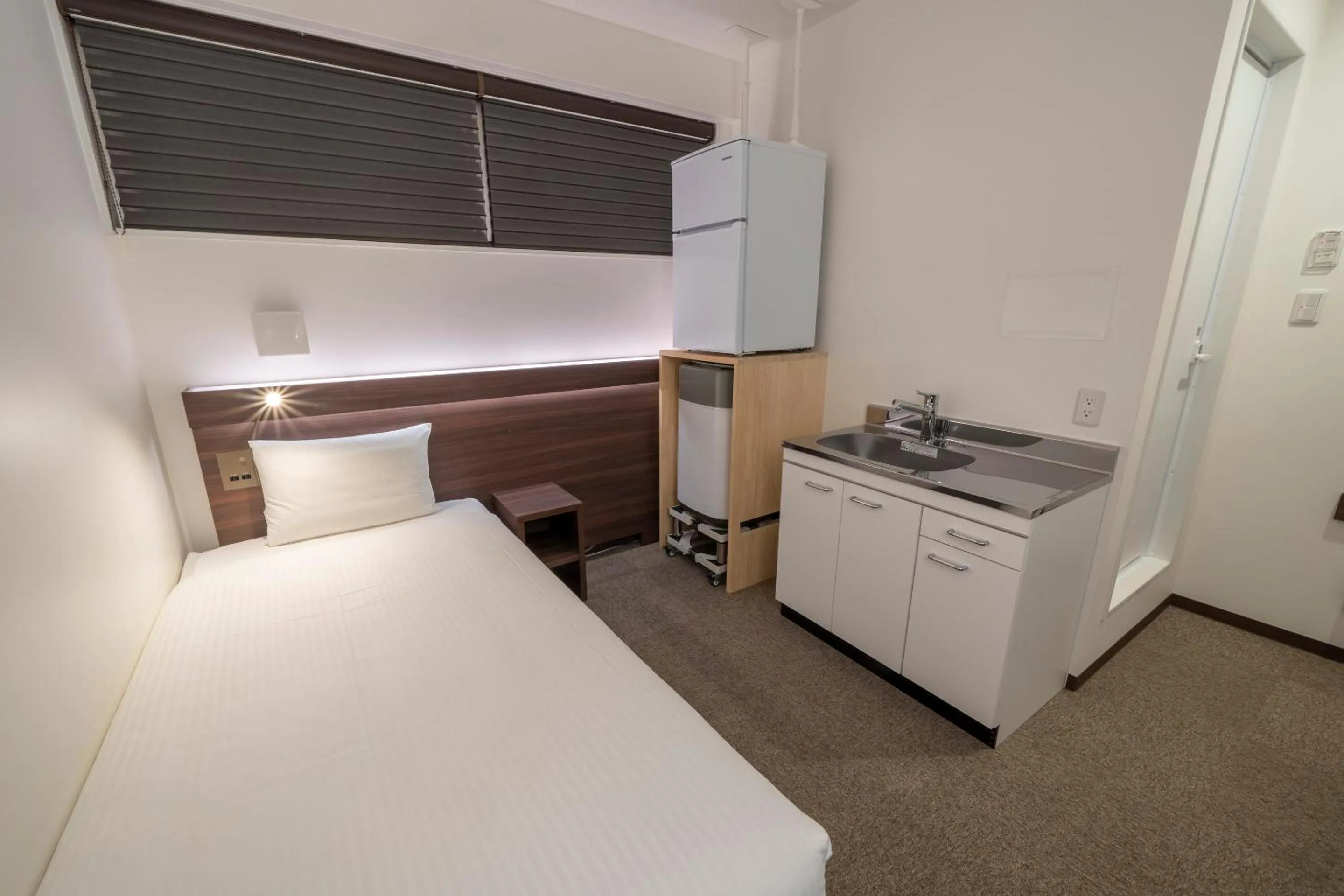 Bed in RESI STAY Jisco Hotel Kyoto Goshonishi