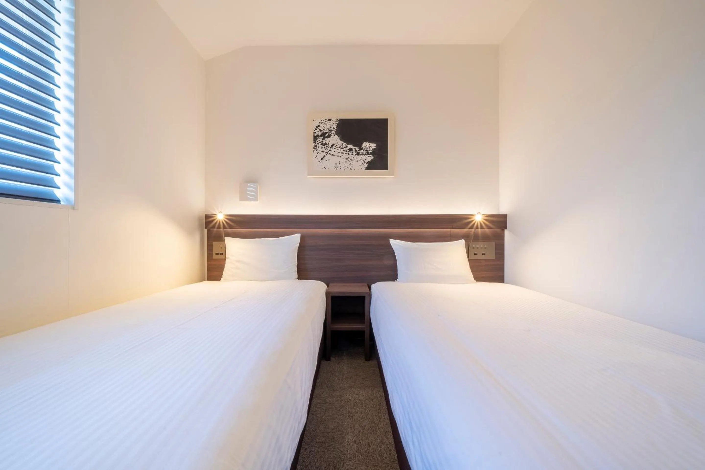 Bed in RESI STAY Jisco Hotel Kyoto Goshonishi